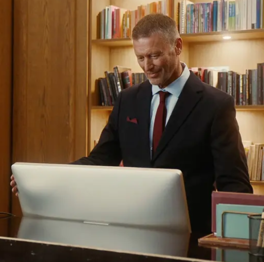 Man working in hospitality looking at computer