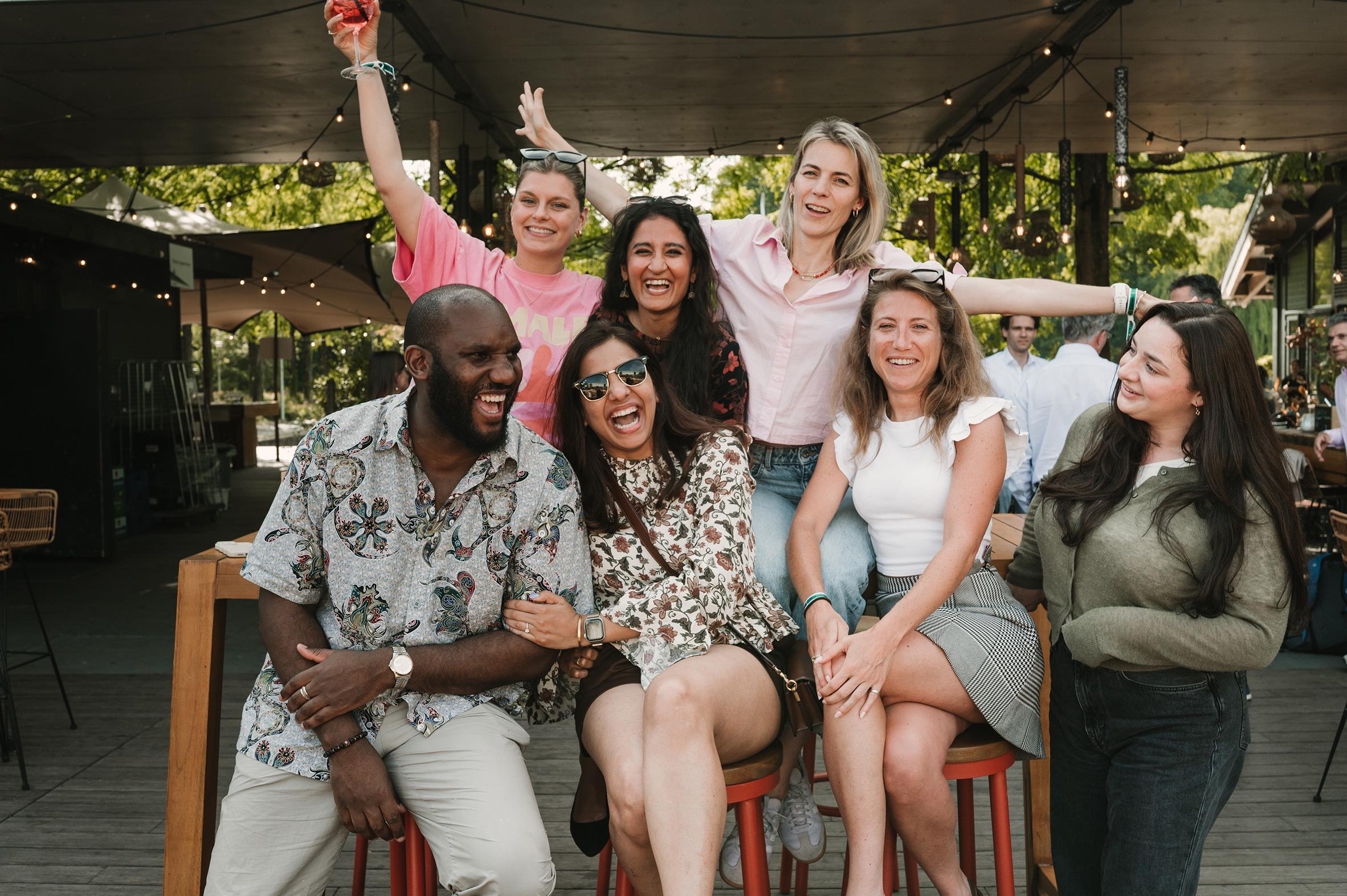 a group of colleagues posing and laughing into the camera  