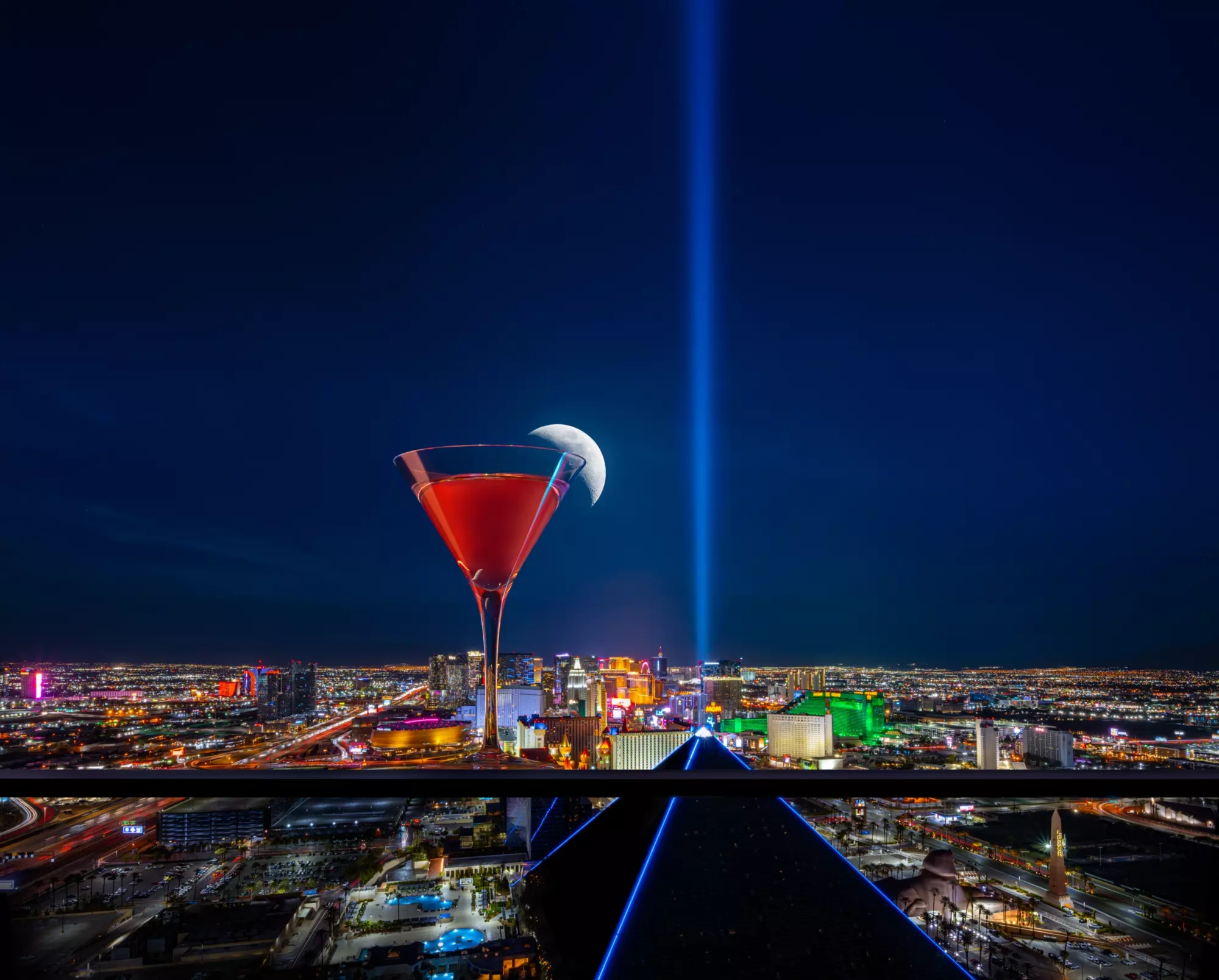 A cocktail in a martini glass on the rooftop of the Skyfall lounge.