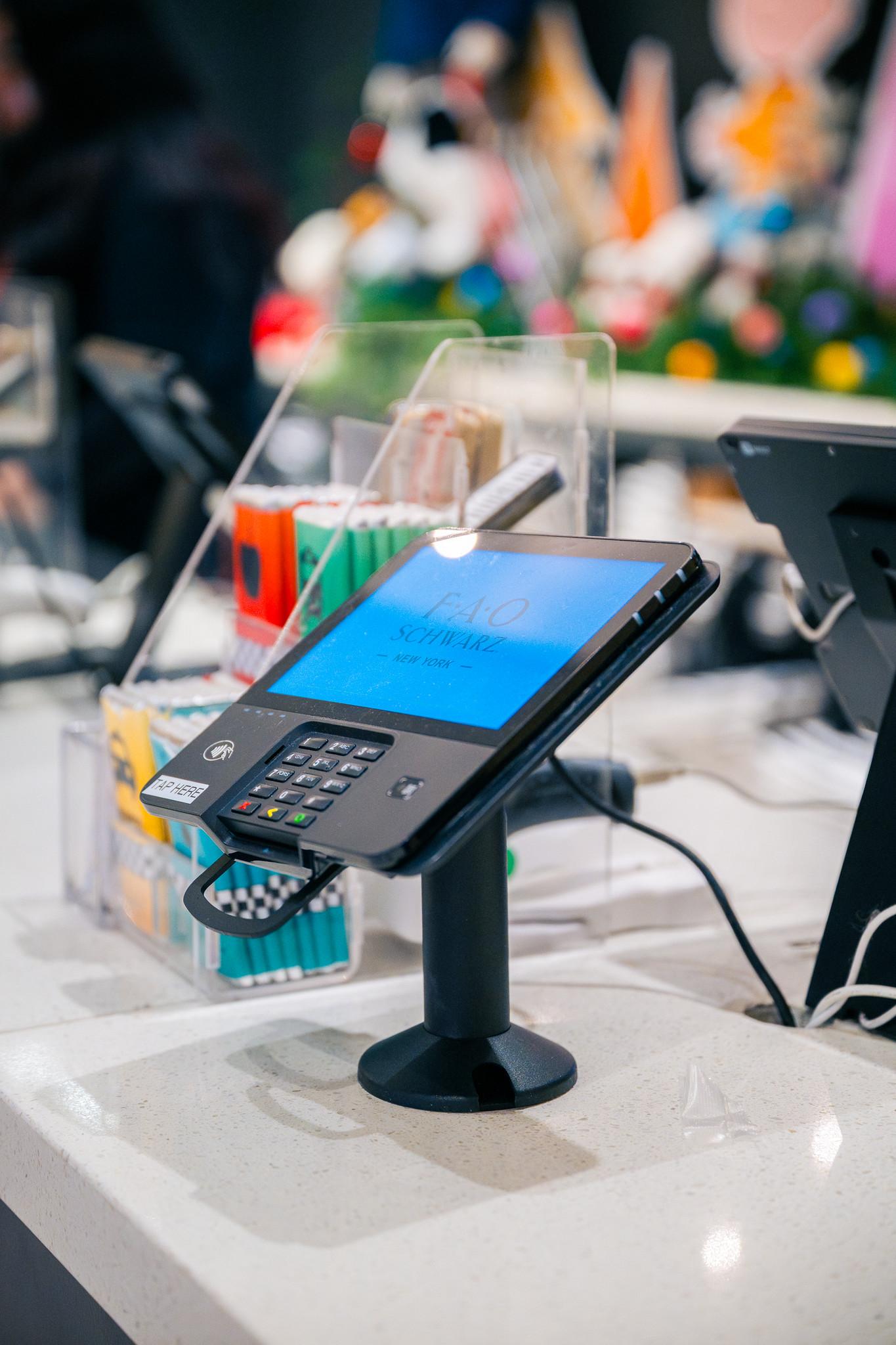 Point-of-sale terminal with a screen displaying a transaction, used for payment processing.