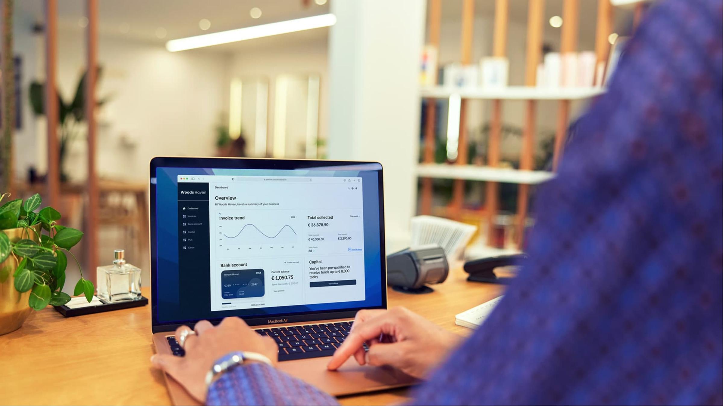Person viewing Adyen dashboard on a laptop screen with overview of financial data.