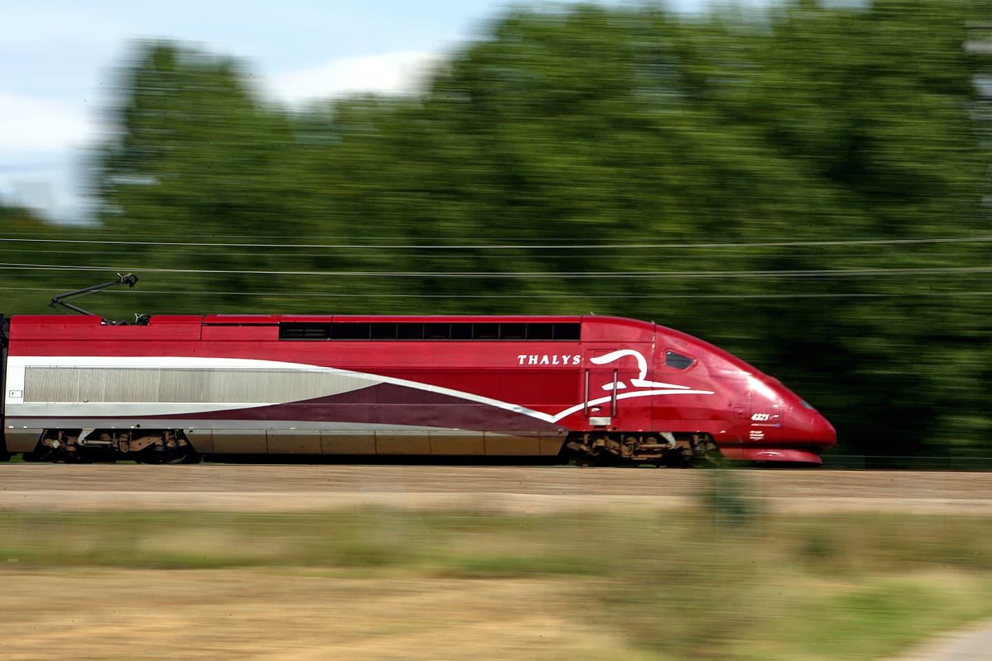 High-speed red Thalys train in motion.