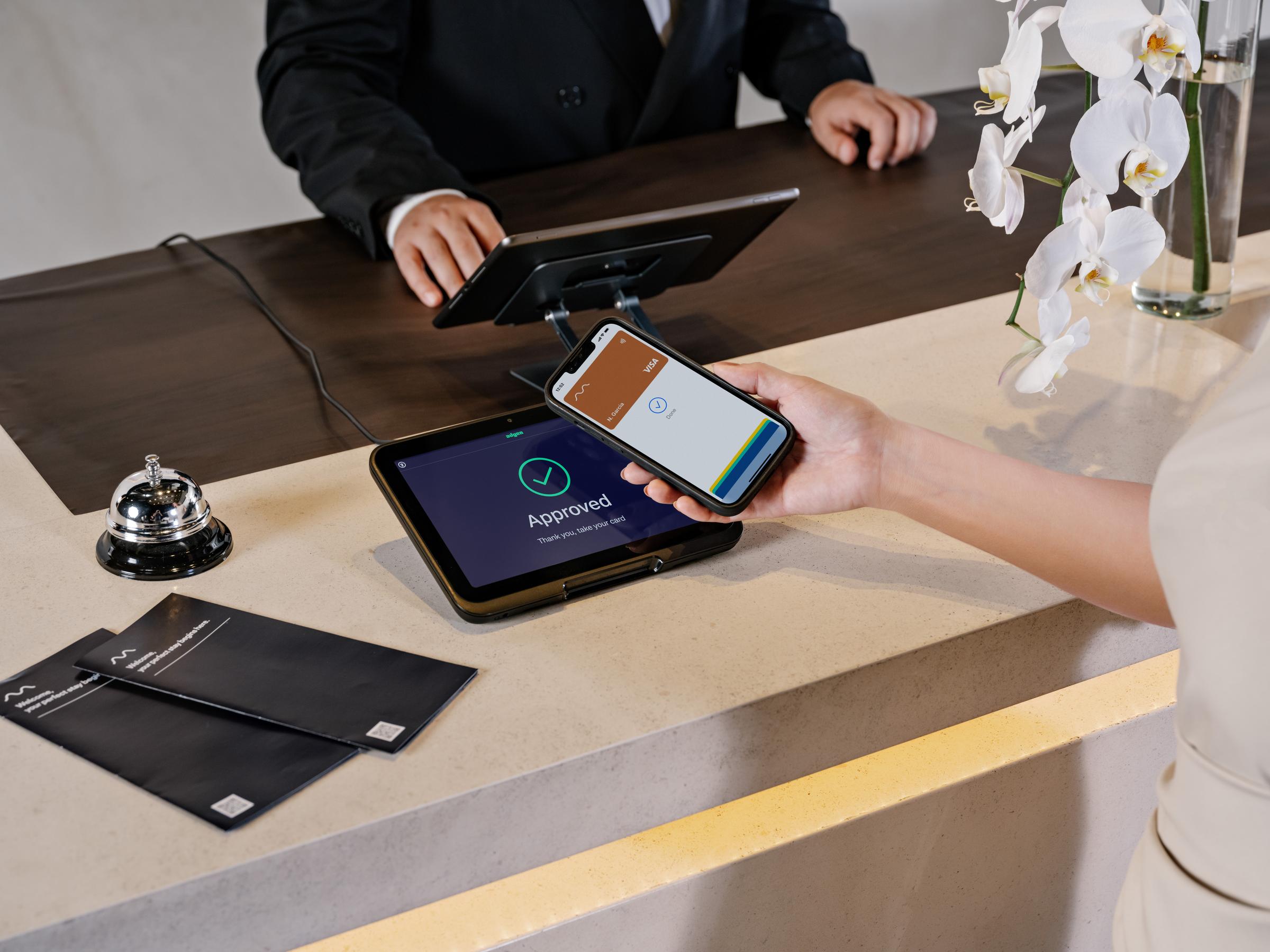 woman paying her stay at a hotel