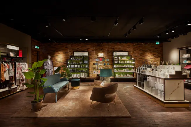 A modern retail shop with seating area, shelves, and payment terminals provided by Adyen.