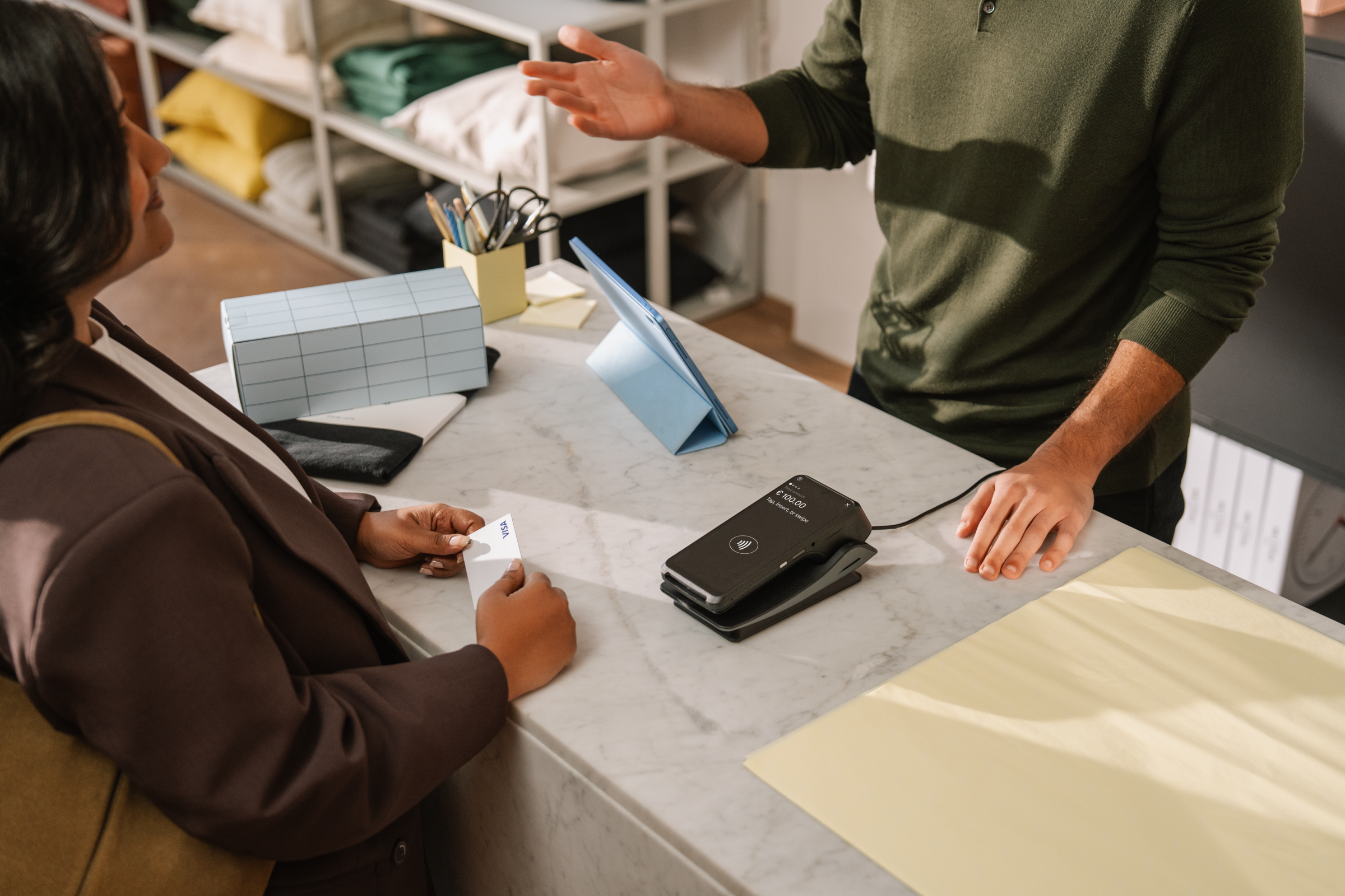 Woman paying with card at counter