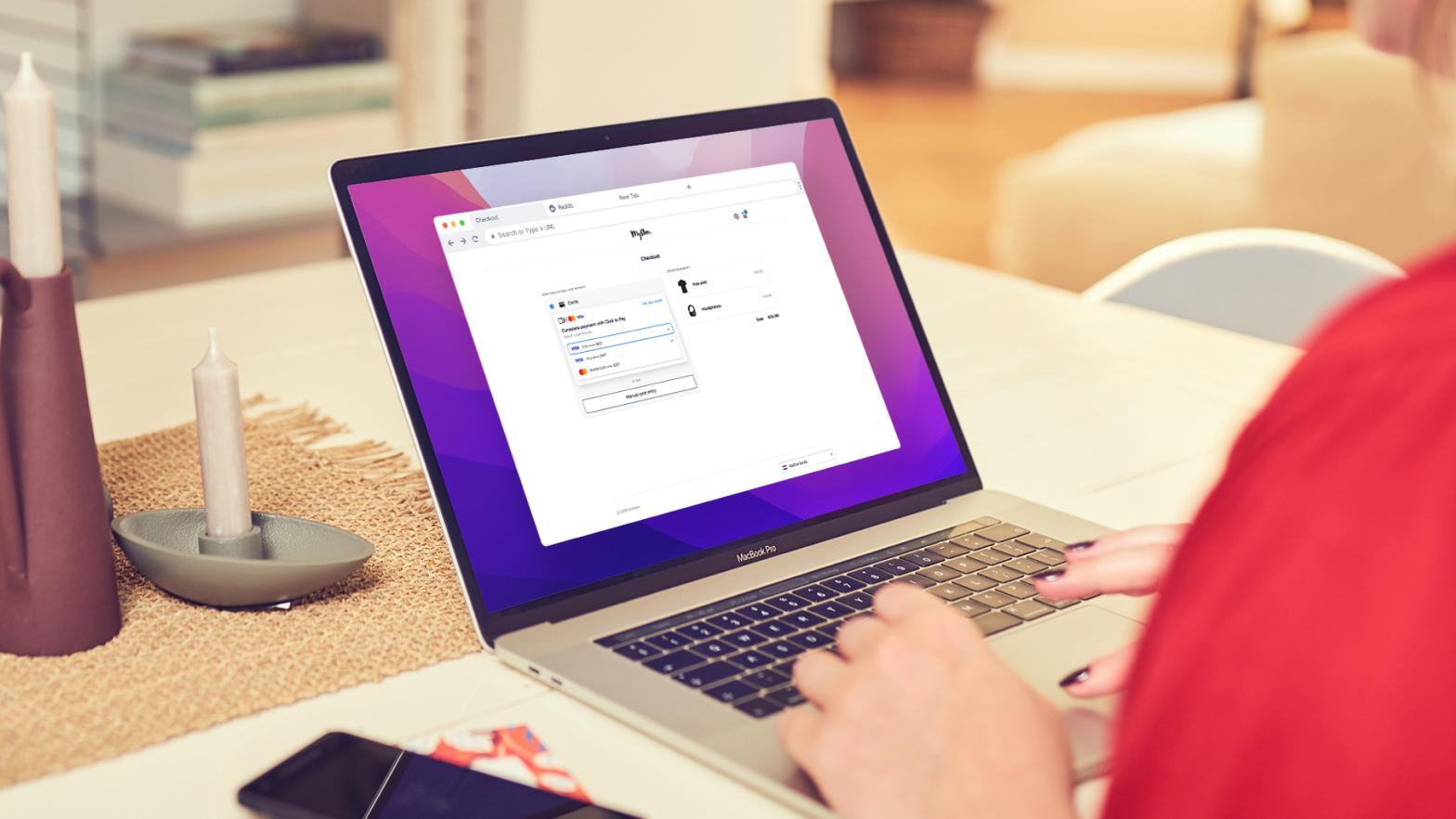 Person using a laptop displaying a payment checkout interface with a credit card form.