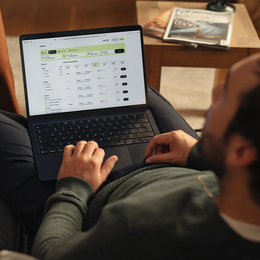 man with laptop looking for flights