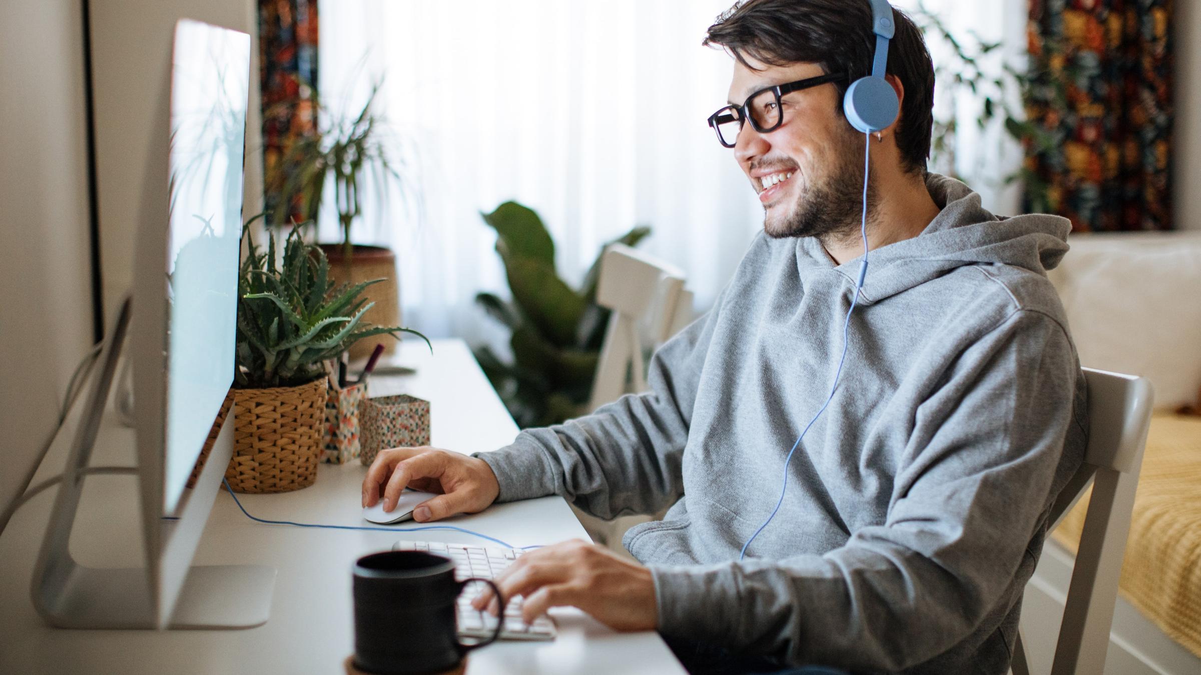 Man sitting on his computer smiling