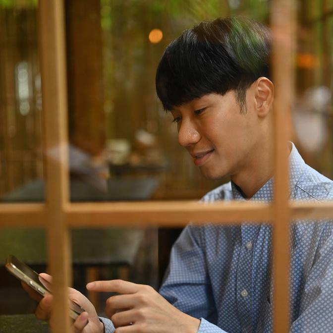 A woman shopping on her tablet with a credit card in her hand.