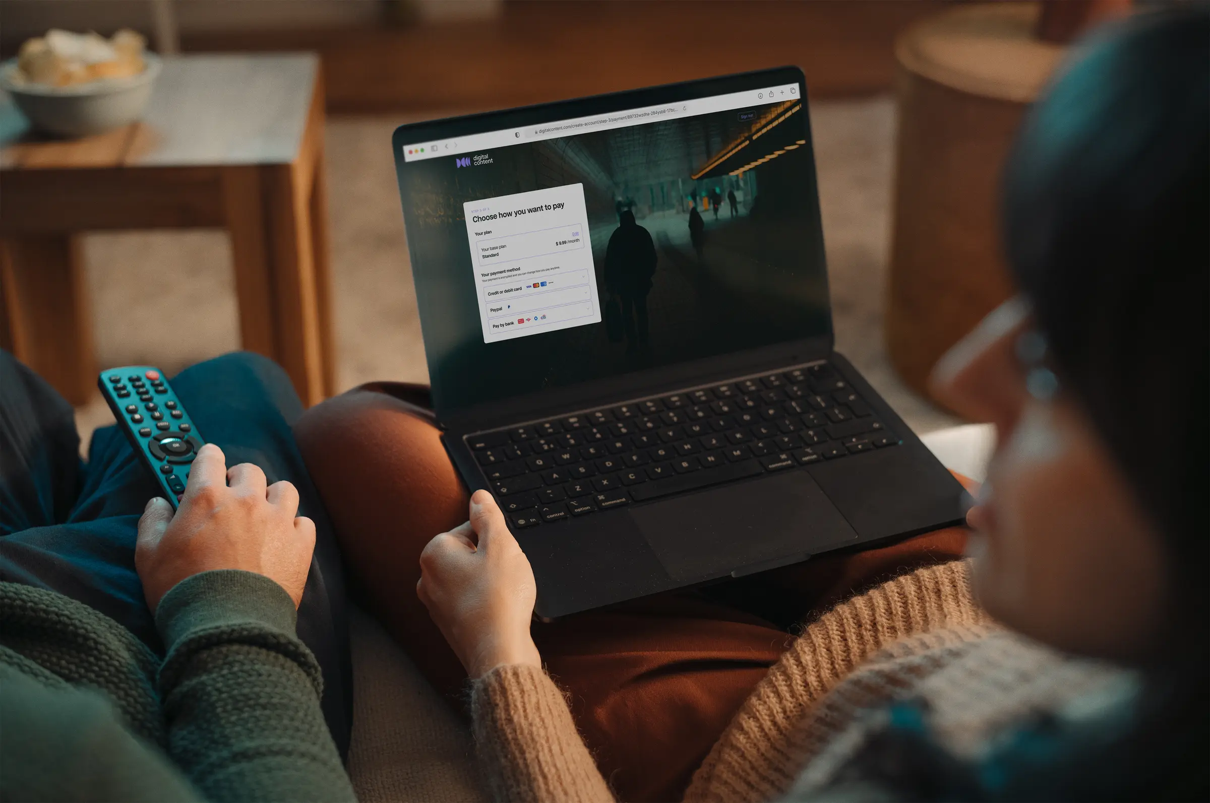 People on the couch finalising the streaming/digital content subscription