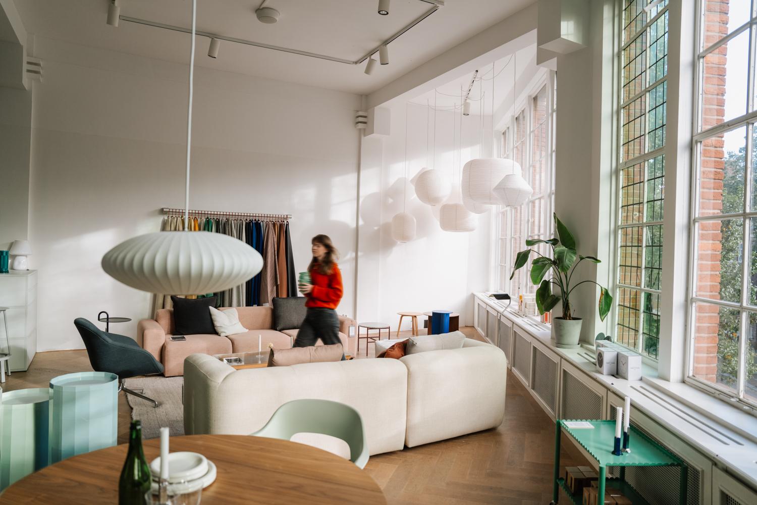 Bright modern office with Adyen employees working and relaxing in a well-lit space