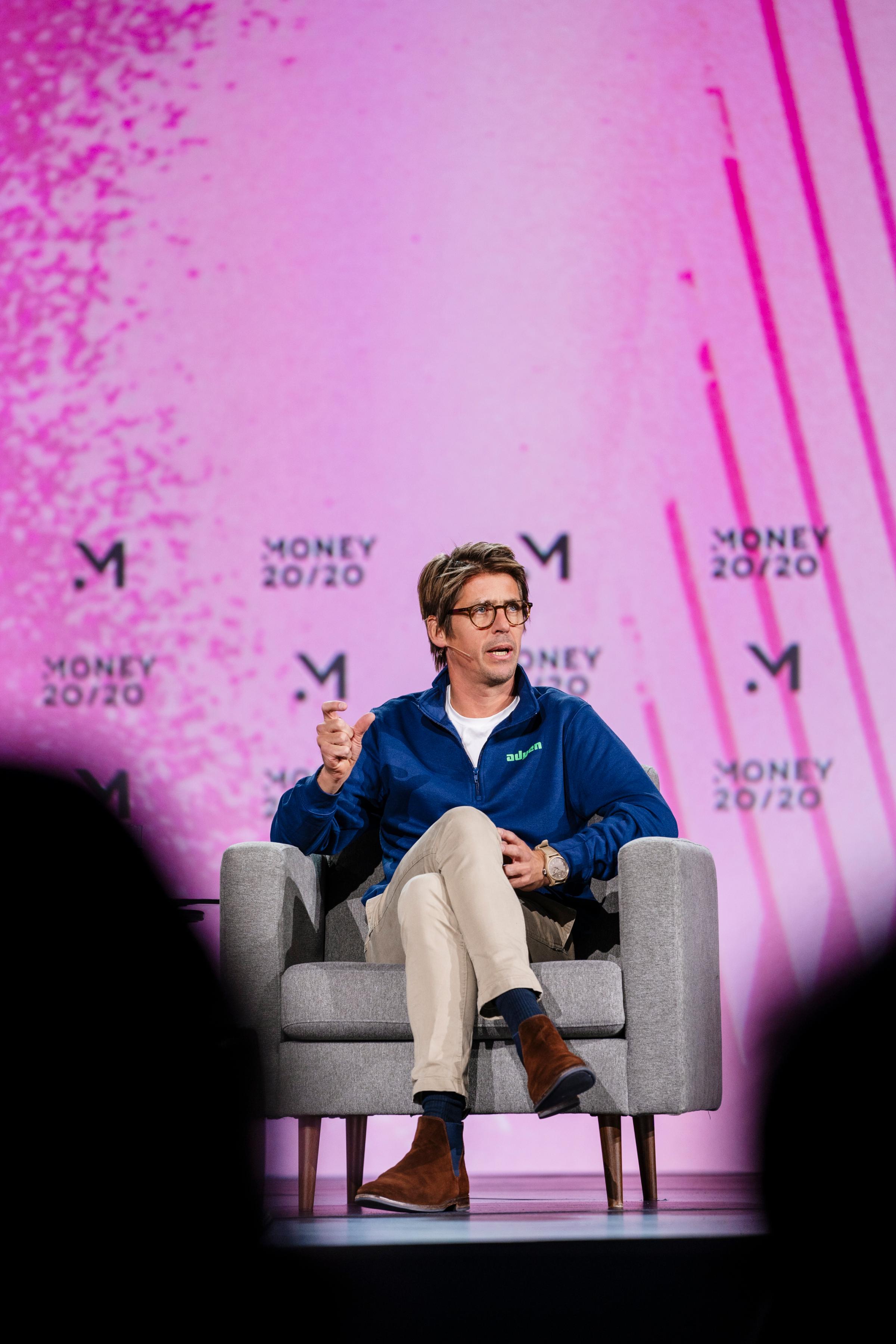 Adyen team member speaking at Money 20/20 event on stage.