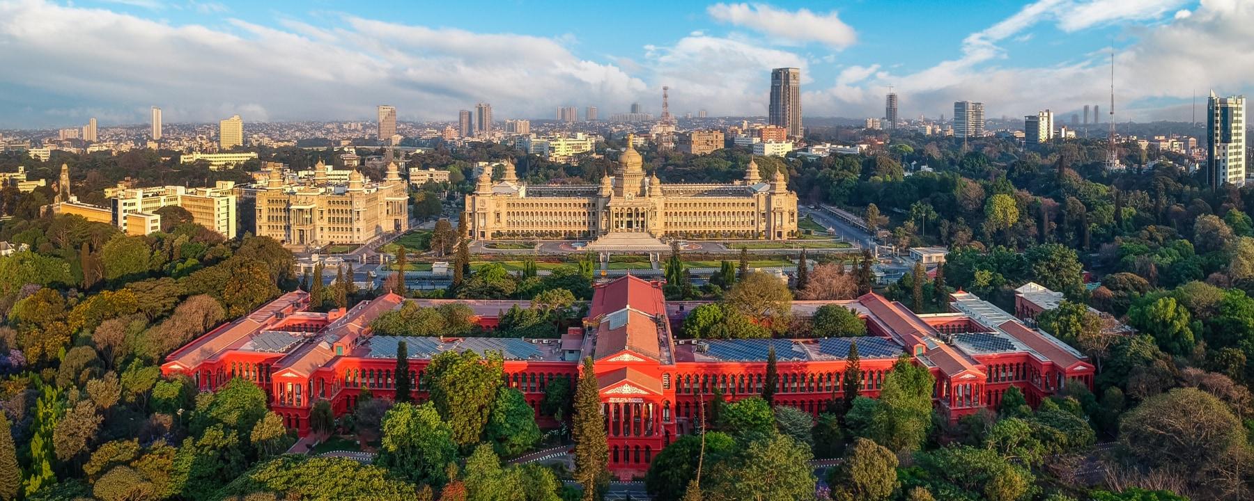 Bird view of Bengaluru city with a Vidhana Soudha building in the centre.