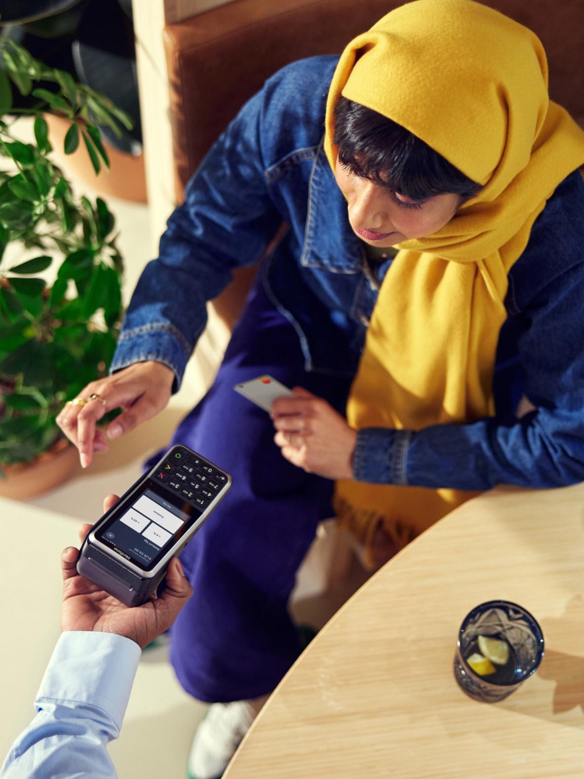 Person making a contactless payment using a mobile point of sale device