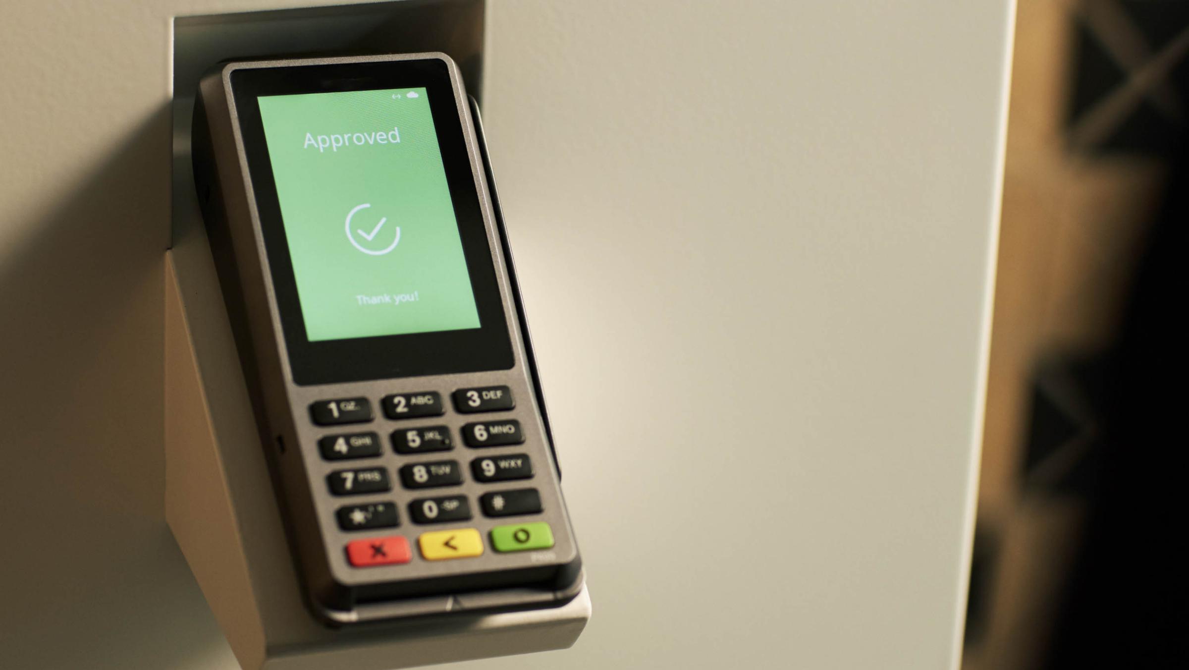 Adyen payment terminal showing an 'Approved' message with a check mark and 'Thank you' text.