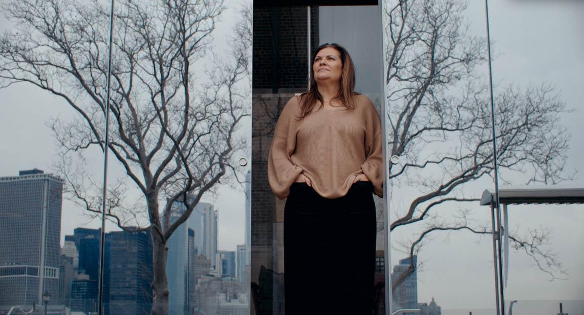 Janine DiGioacchino, CEO US, QC Terme, overlooks the skyline of Manhatten