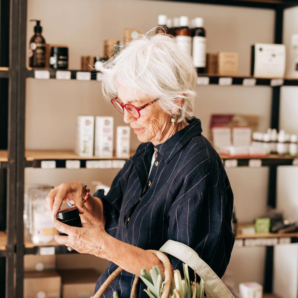 A boomer checking her wallet in a store