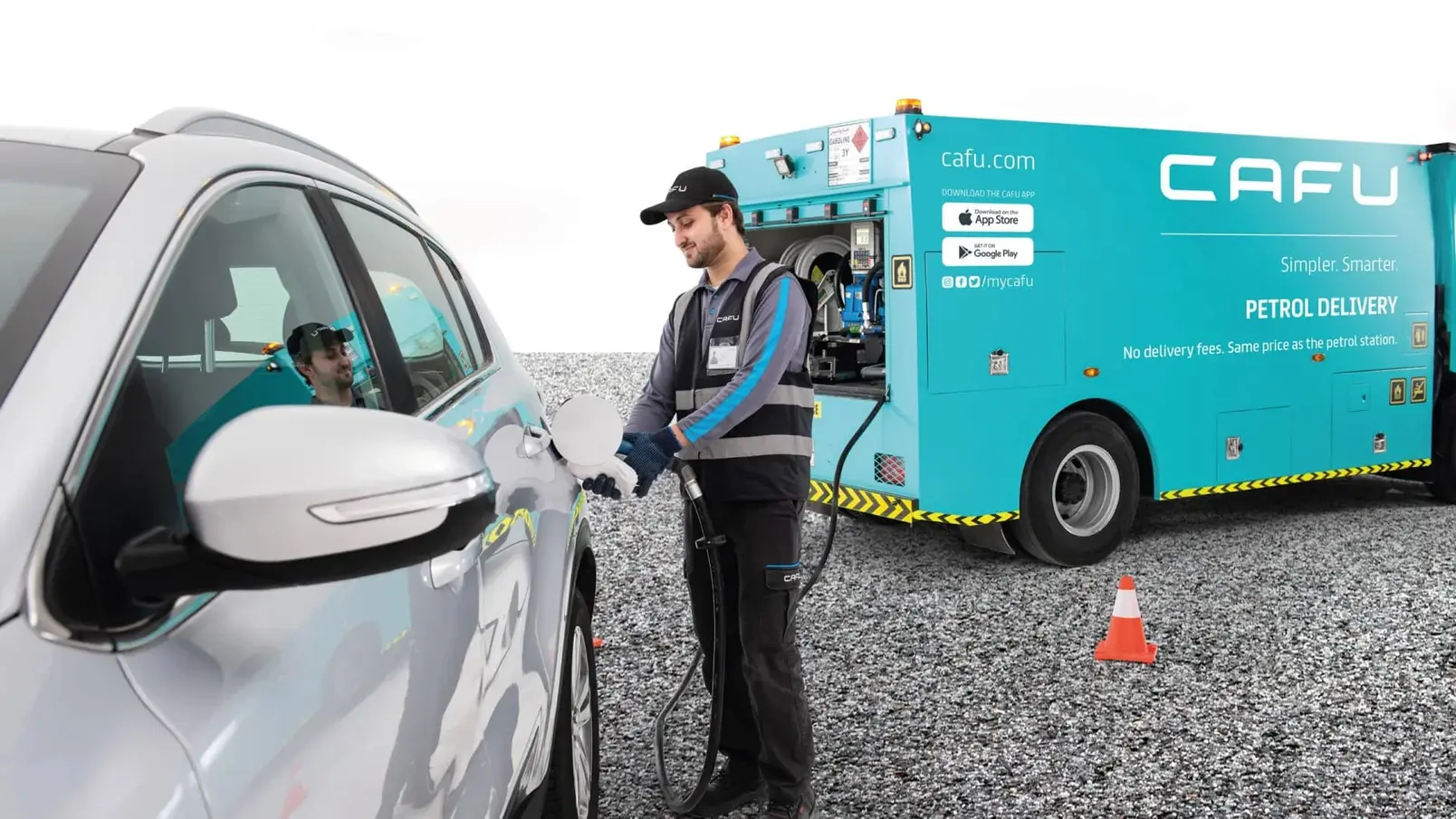 Fuel delivery worker refueling a car from a CAFU petrol delivery truck.