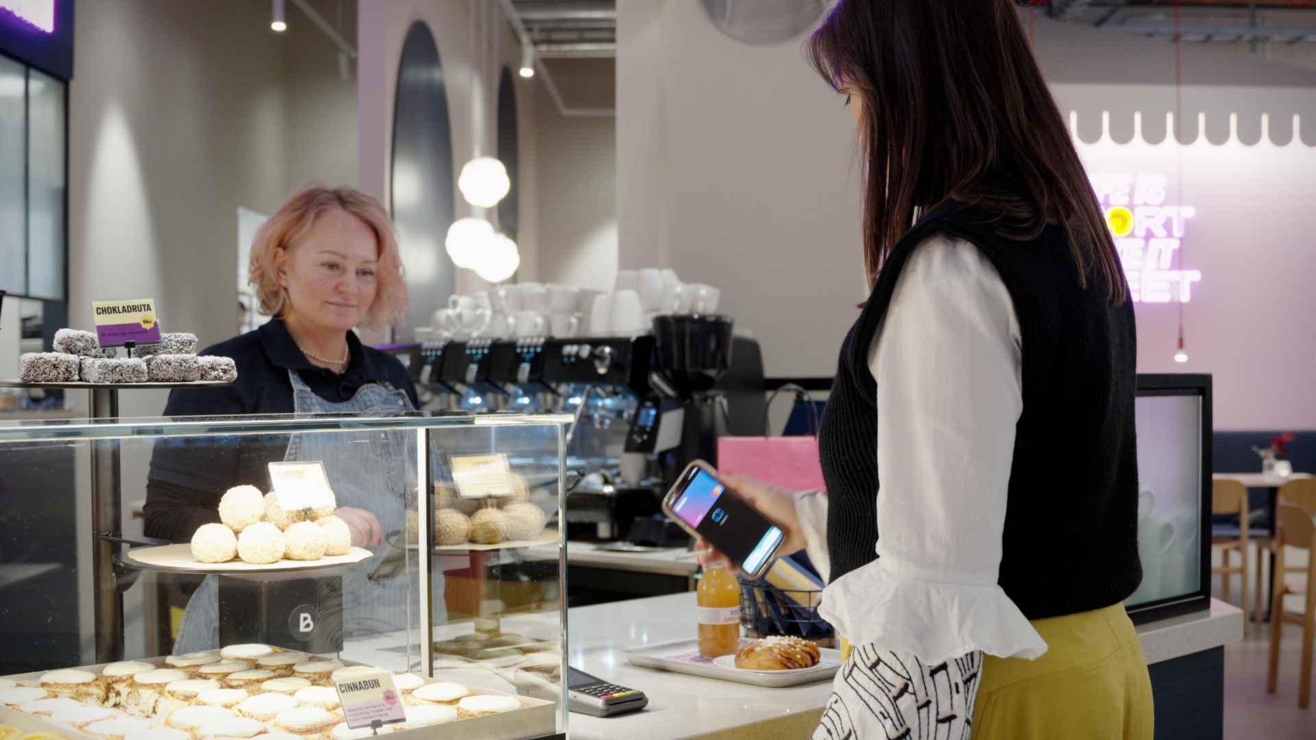 Woman buying dessert at a store