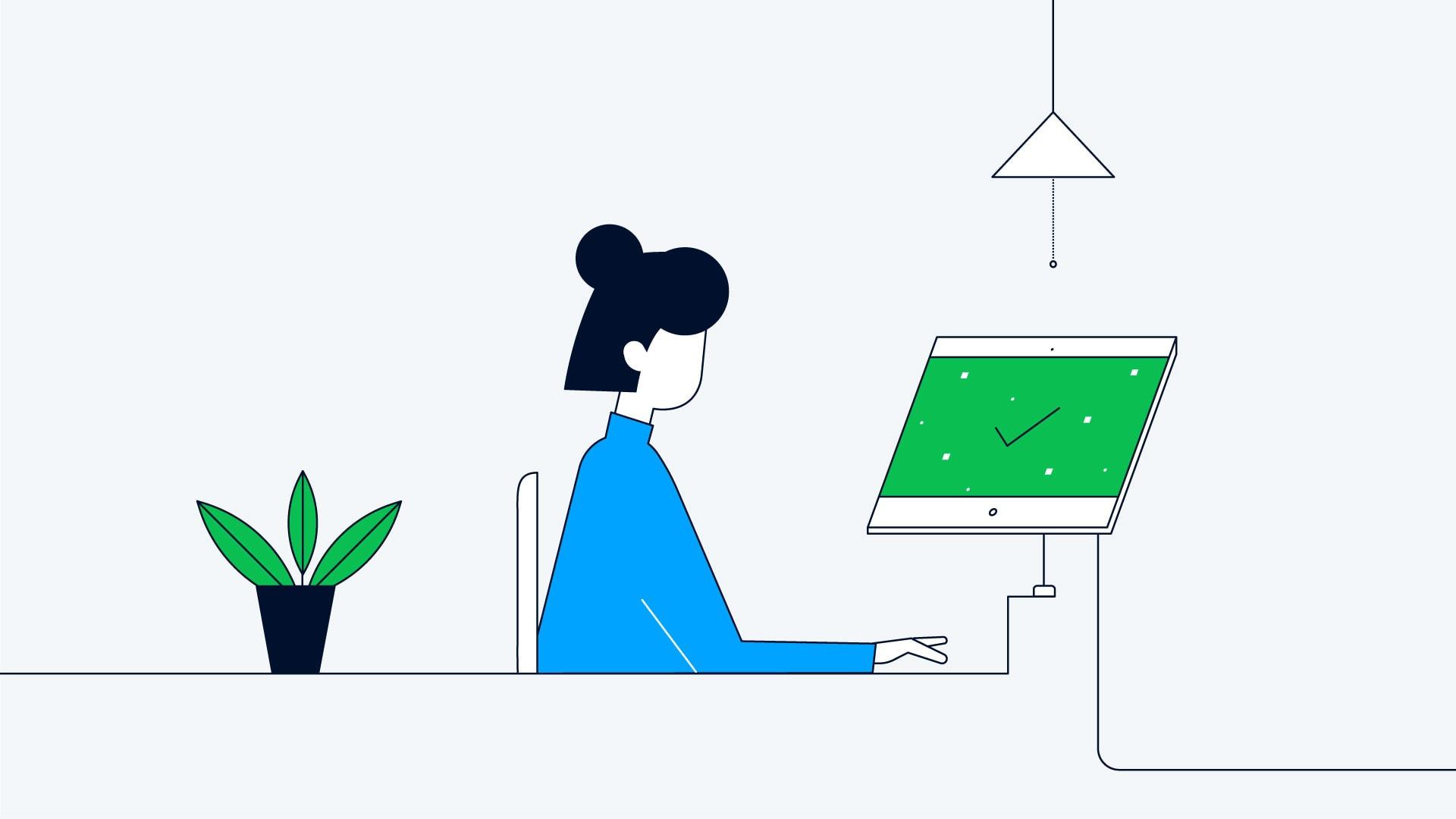 Een persoon zit aan een bureau met een computerscherm dat een vinkje weergeeft.