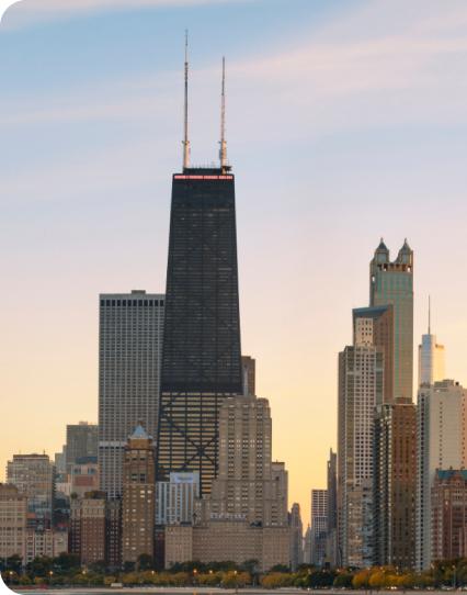 Chicago skyline with prominent skyscraper during sunset.