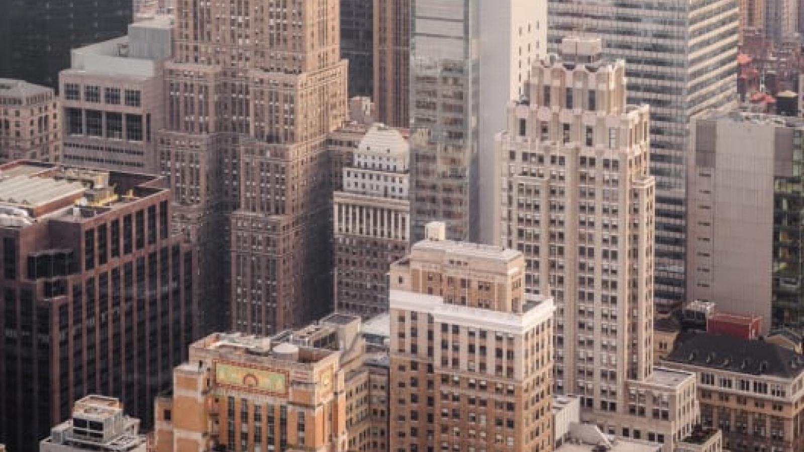 Aerial view of dense city buildings with varying architectural styles.