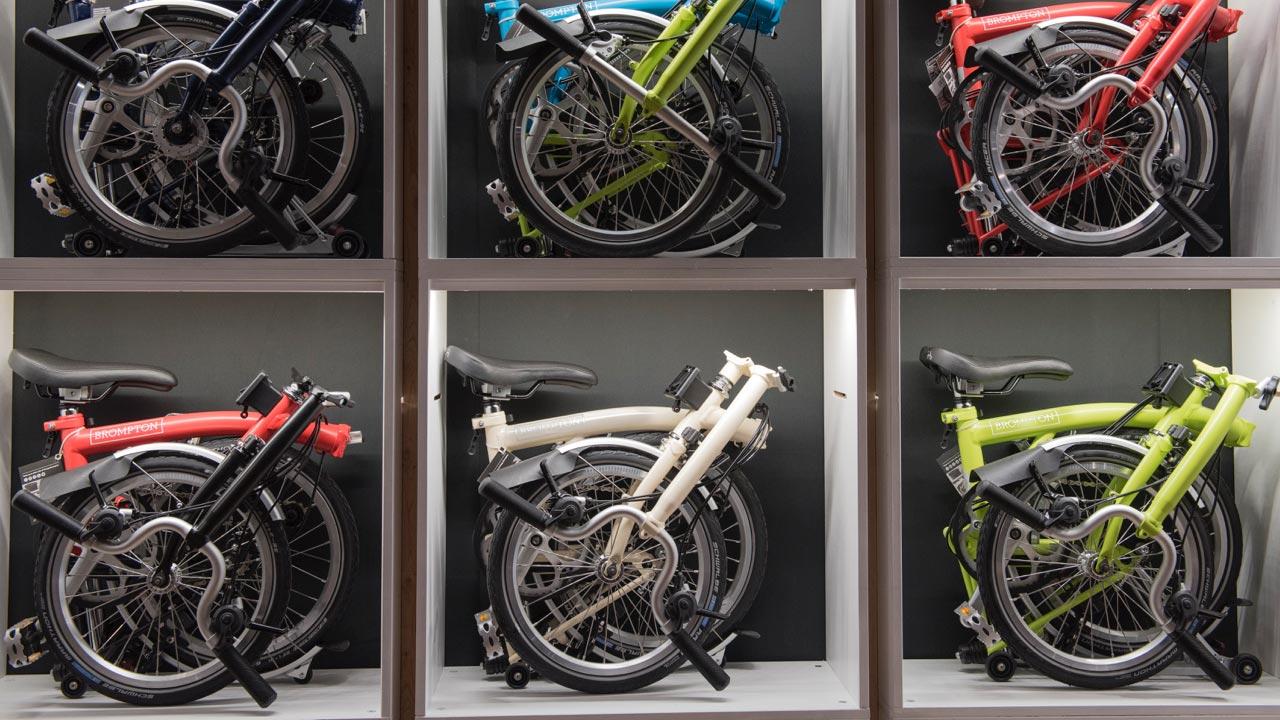 Assorted folded Brompton bicycles stored in compartments.