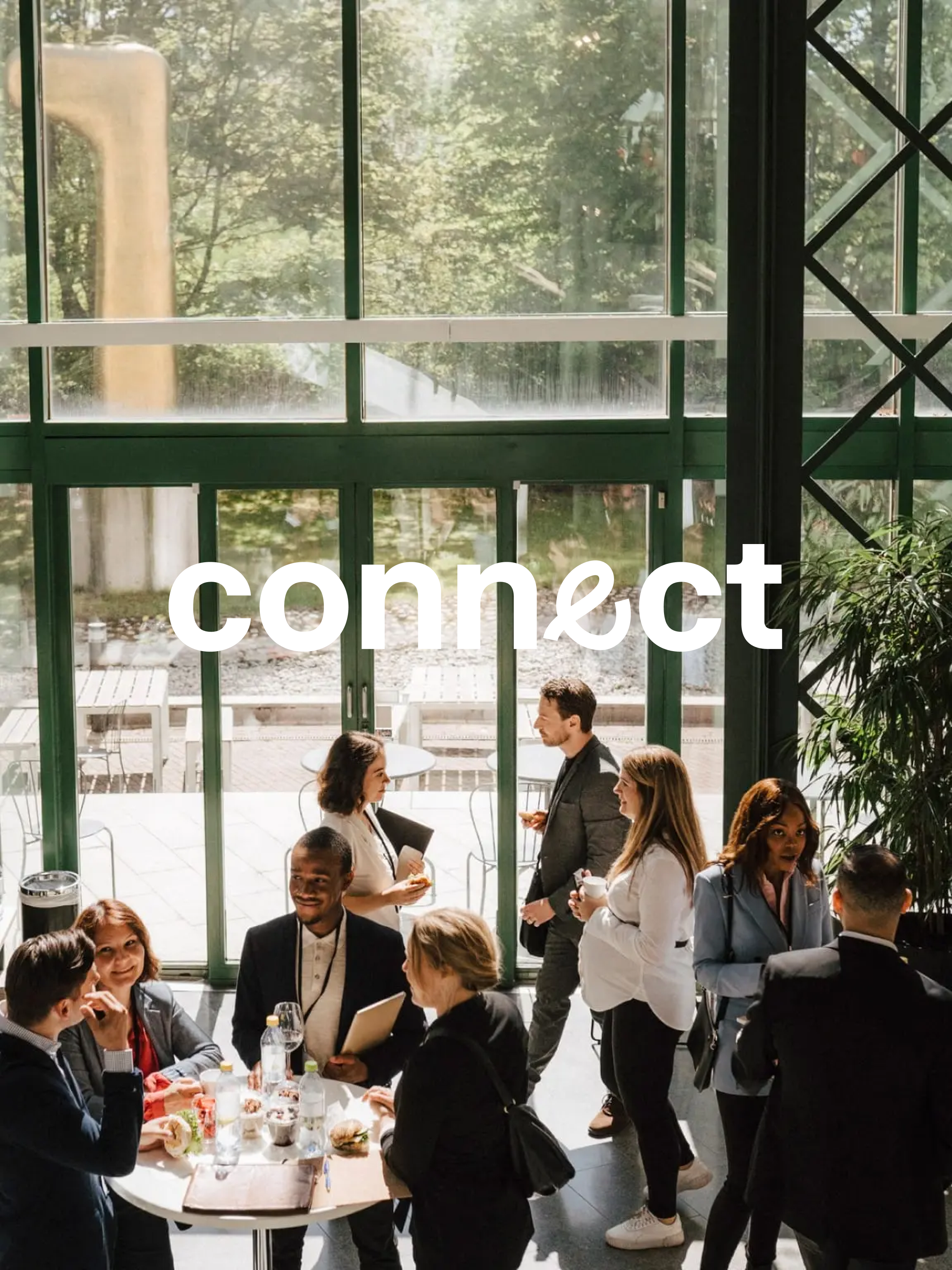Attendees of a networking event chatting in the venue, with Adyen Connect branded elements in the front.