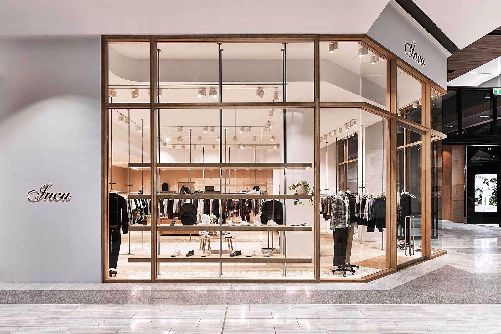 Modern fashion retail store interior with clothing displays.