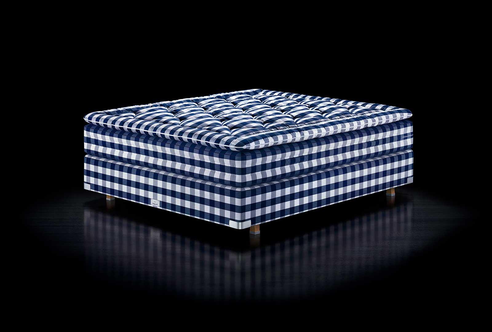 Blue and white checked footstool on a dark background.