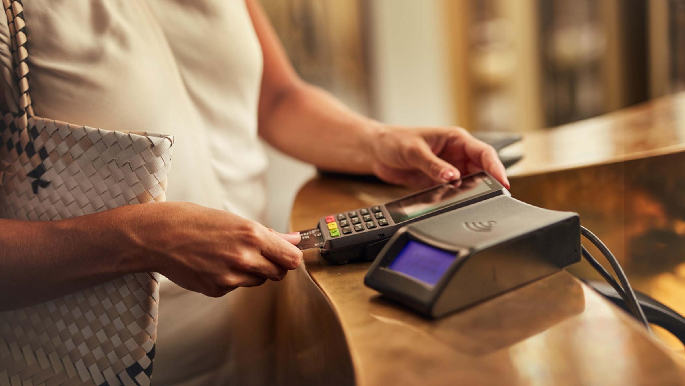 Person making a contactless payment using a card terminal.
