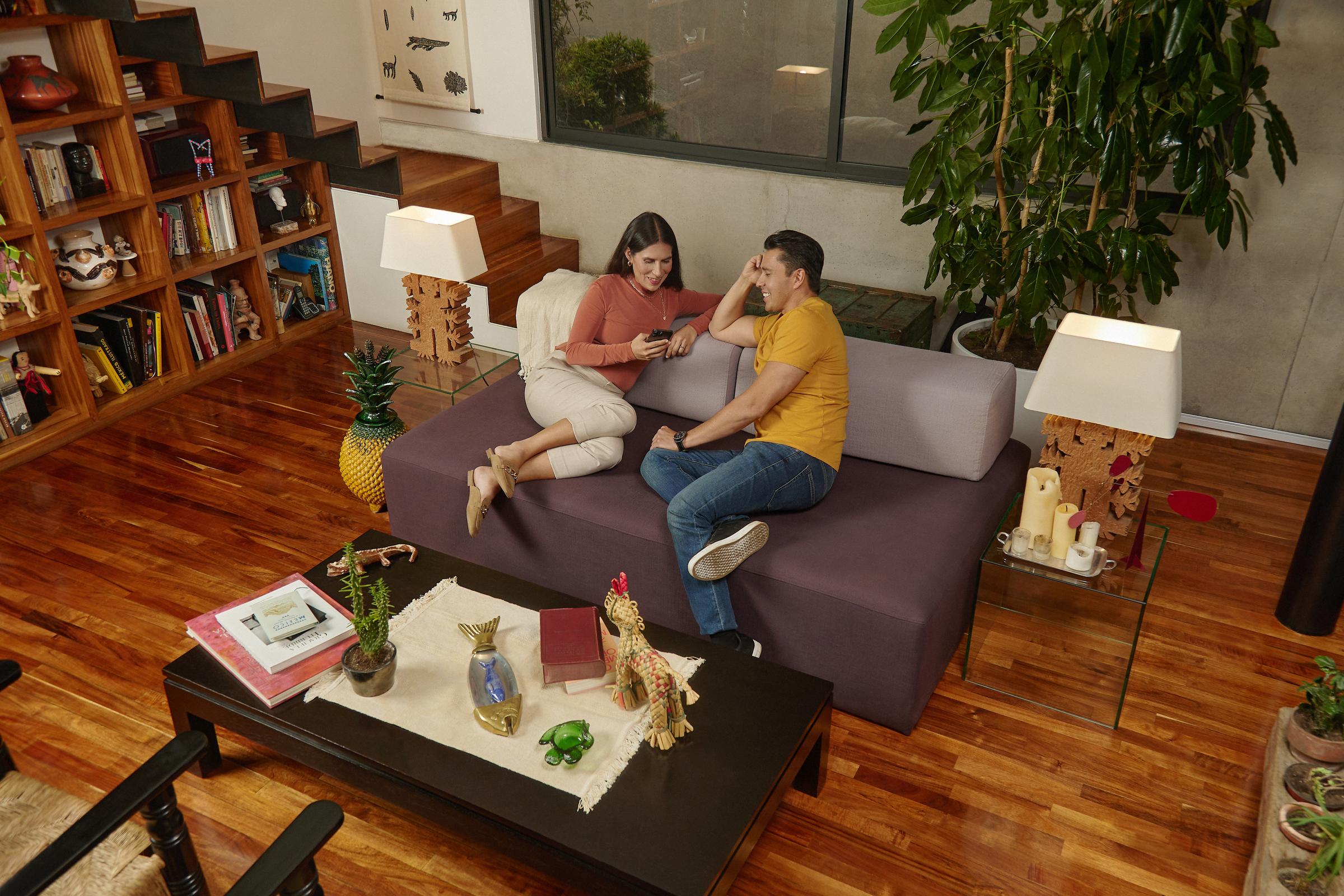 couple on a sofa looking at a phone 