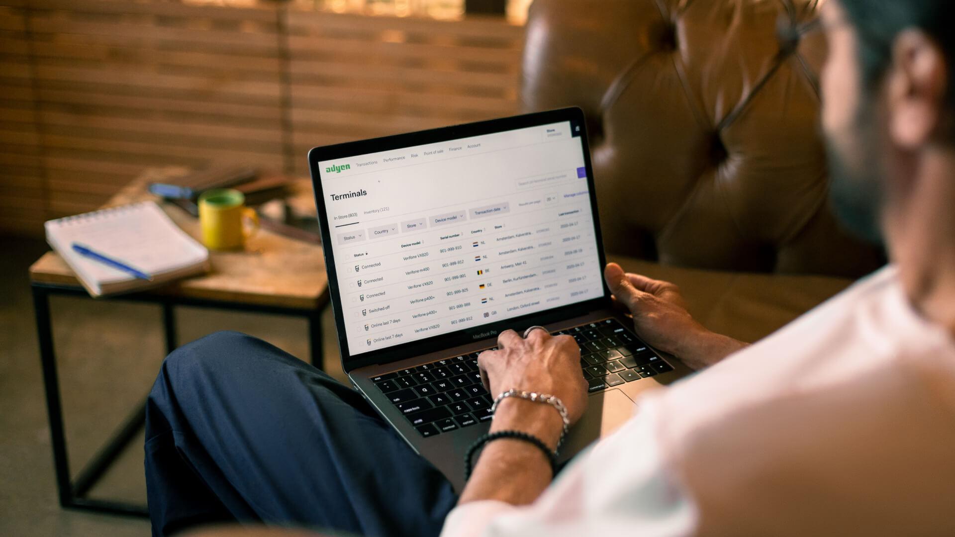 Pessoa usando um laptop com a interface de gerenciamento de terminais Adyen