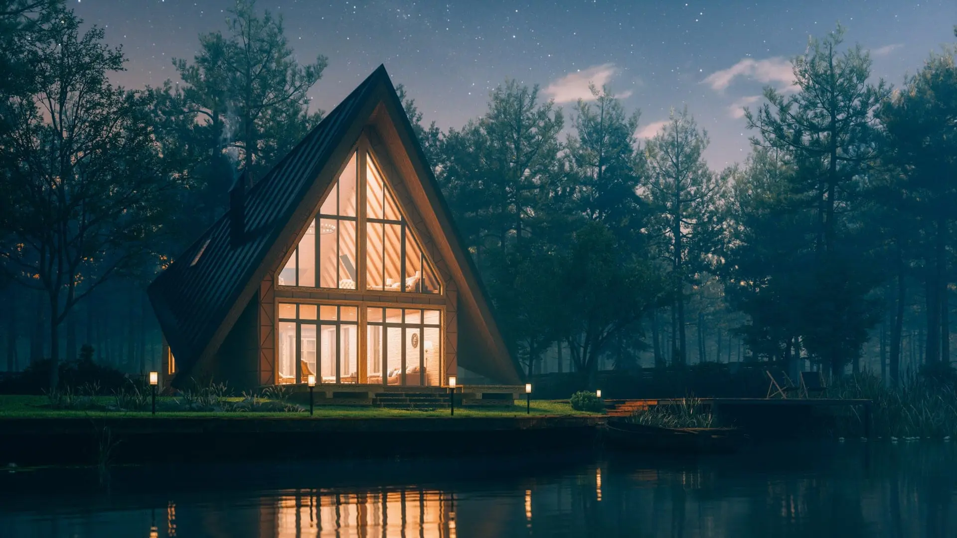 A-frame house with illuminated windows by a tranquil lakeside at dusk under a starry sky in Sweden.