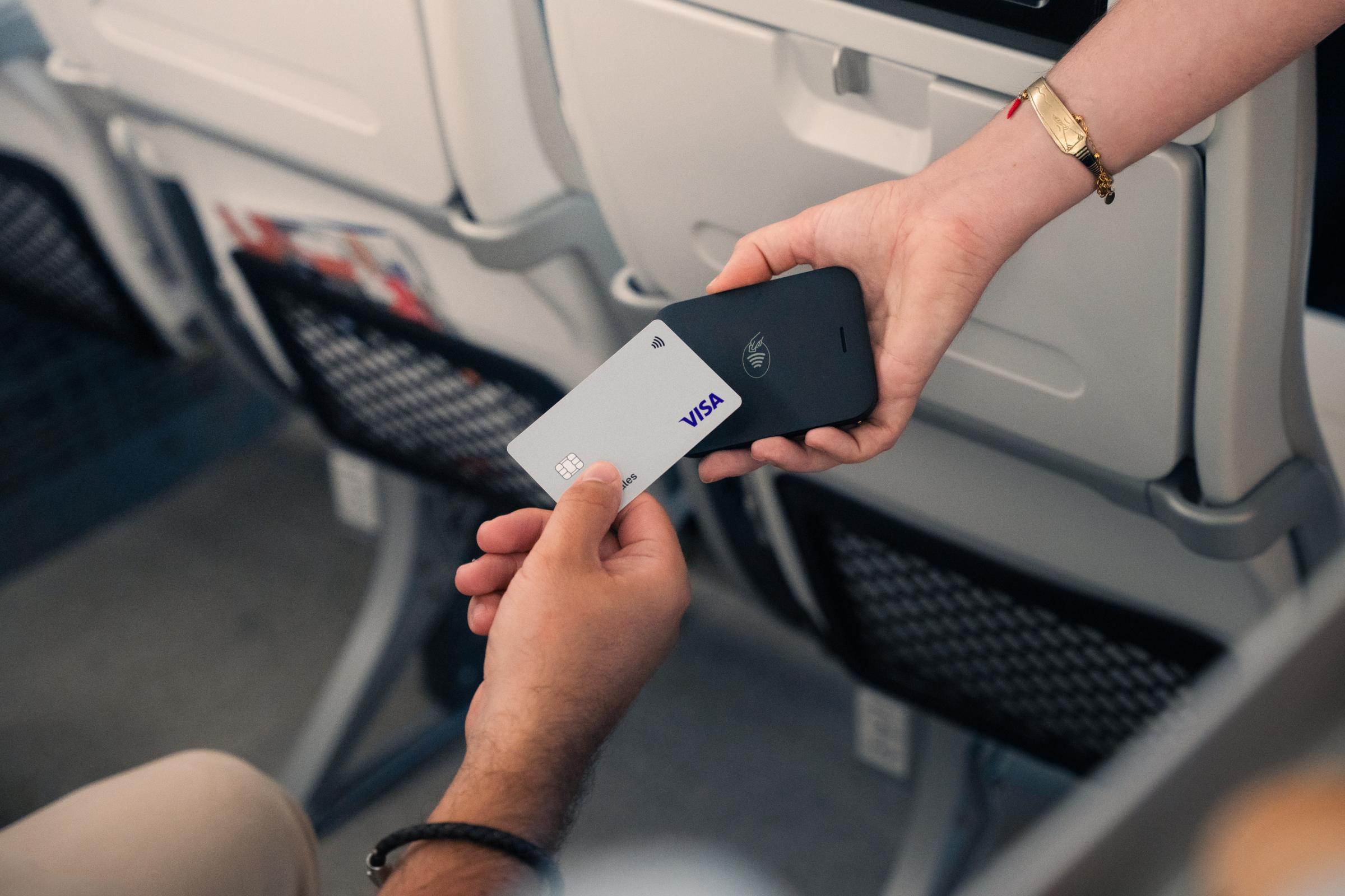 Payment processing with an Adyen terminal during a flight transaction.