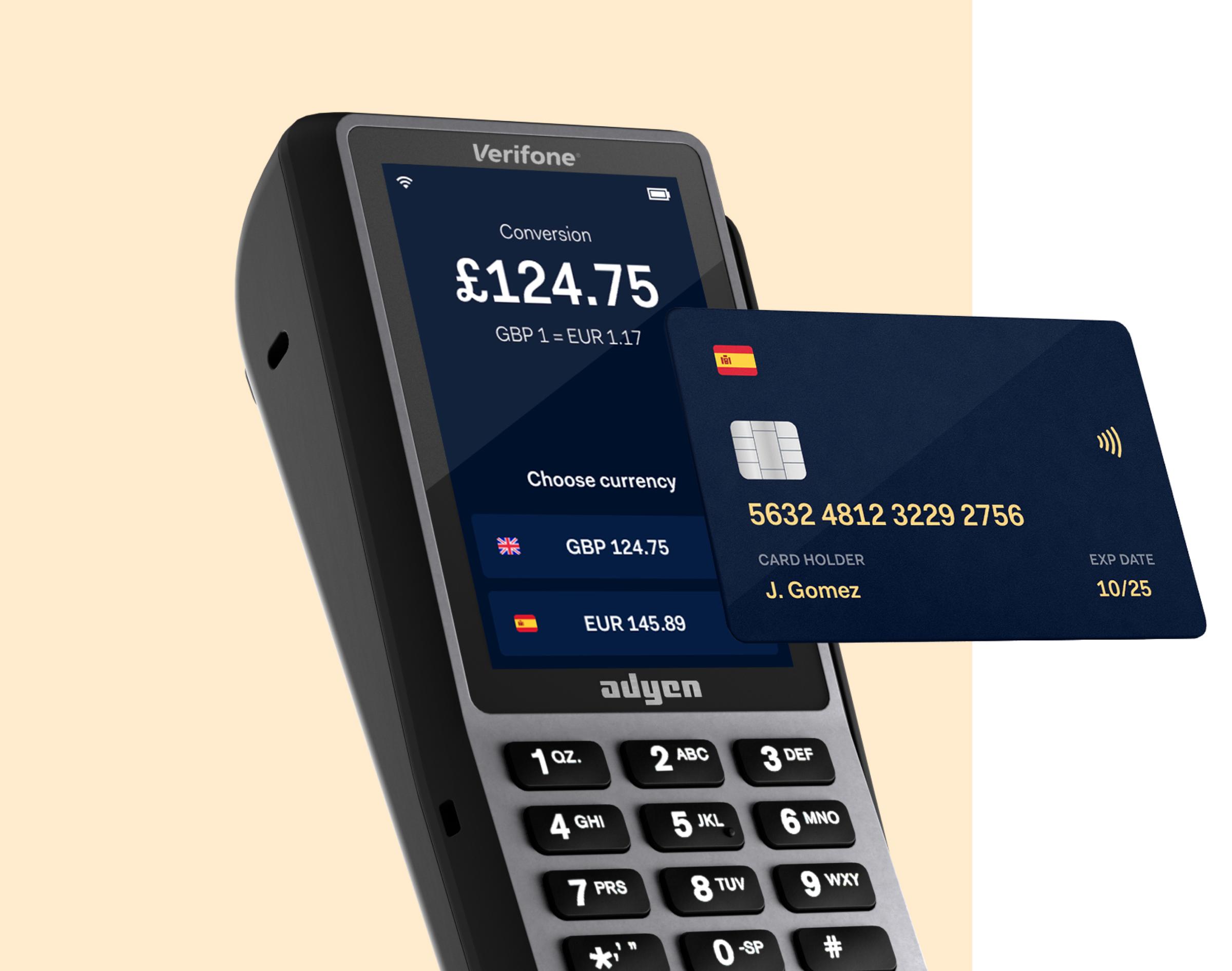 Adyen payment terminal showing currency conversion option and a credit card hovering above