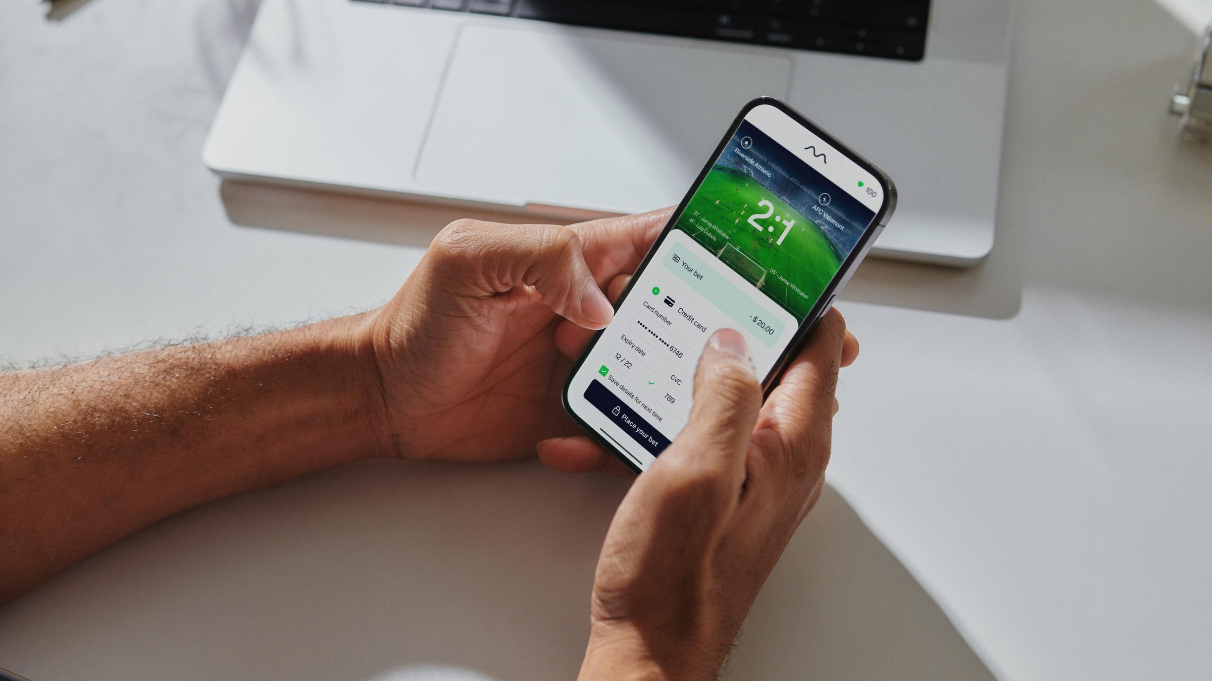 Person on their phone placing a sports bet