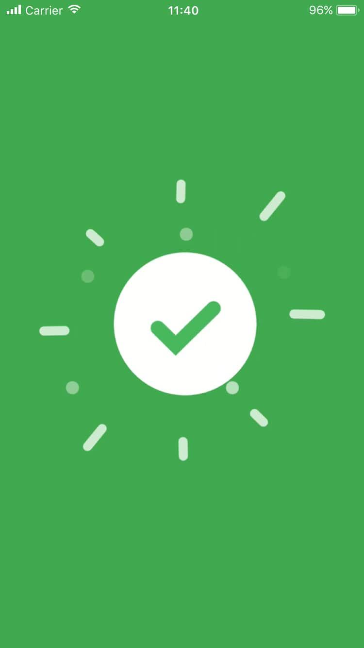 Mobile screen with a white check mark on a green background, indicating a successful transaction.