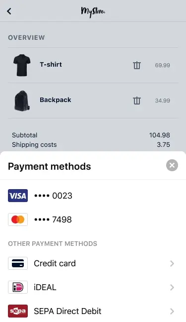 Pantalla de carrito de compras móvil con artículos, costos y opciones de pago Adyen, incluyendo Visa y Mastercard.
