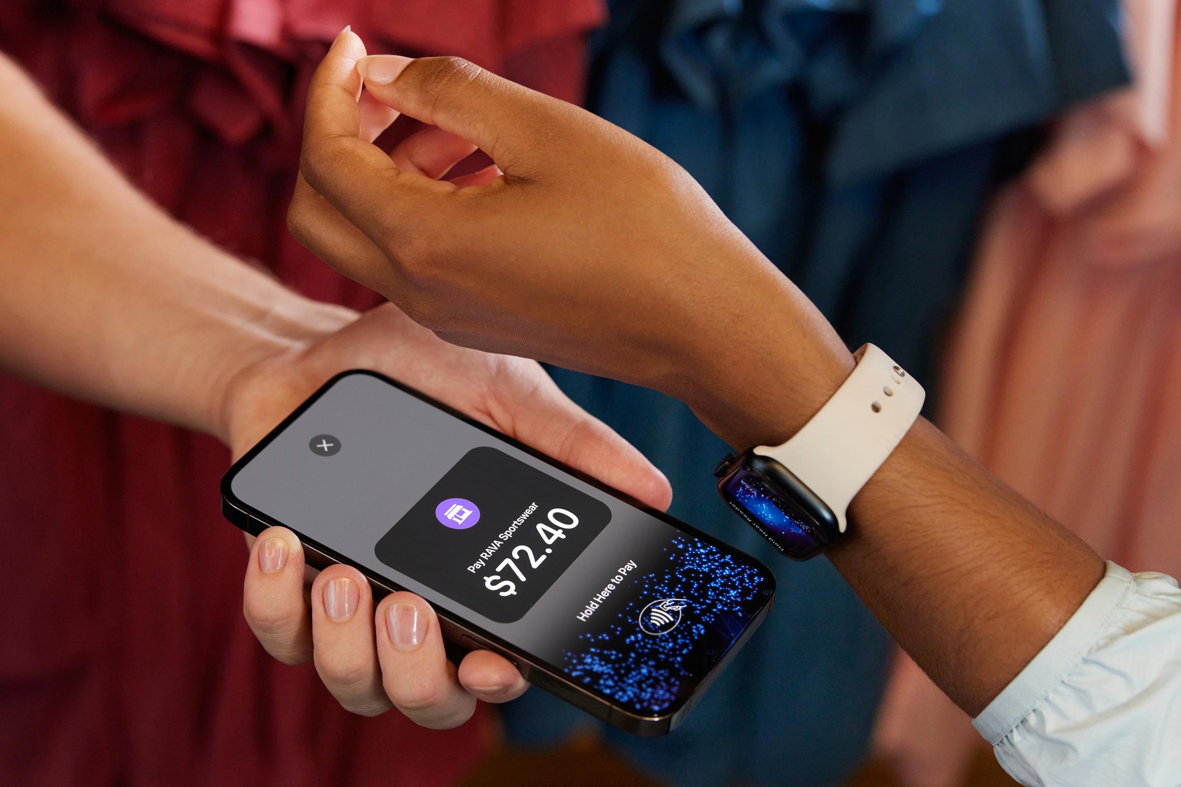 Shop owner and customer using Tap to pay on iPhone with Apple Watch