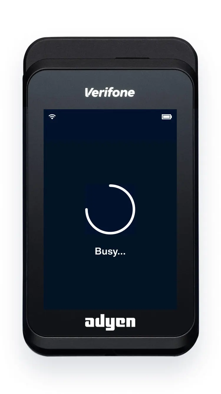 Verifone card terminal with Adyen branding on screen showing busy status.