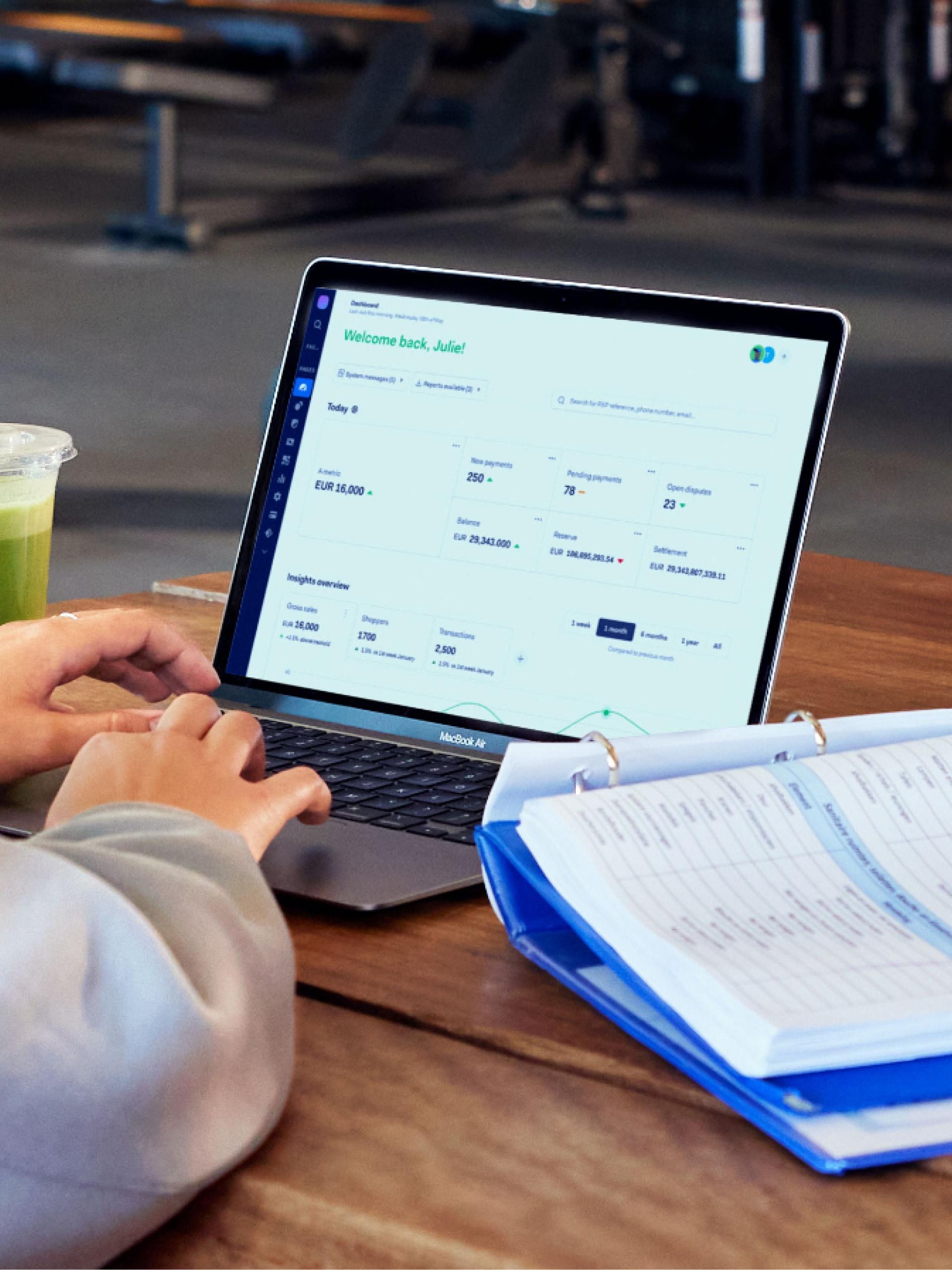Person using a laptop displaying Adyen dashboard with transaction insights.