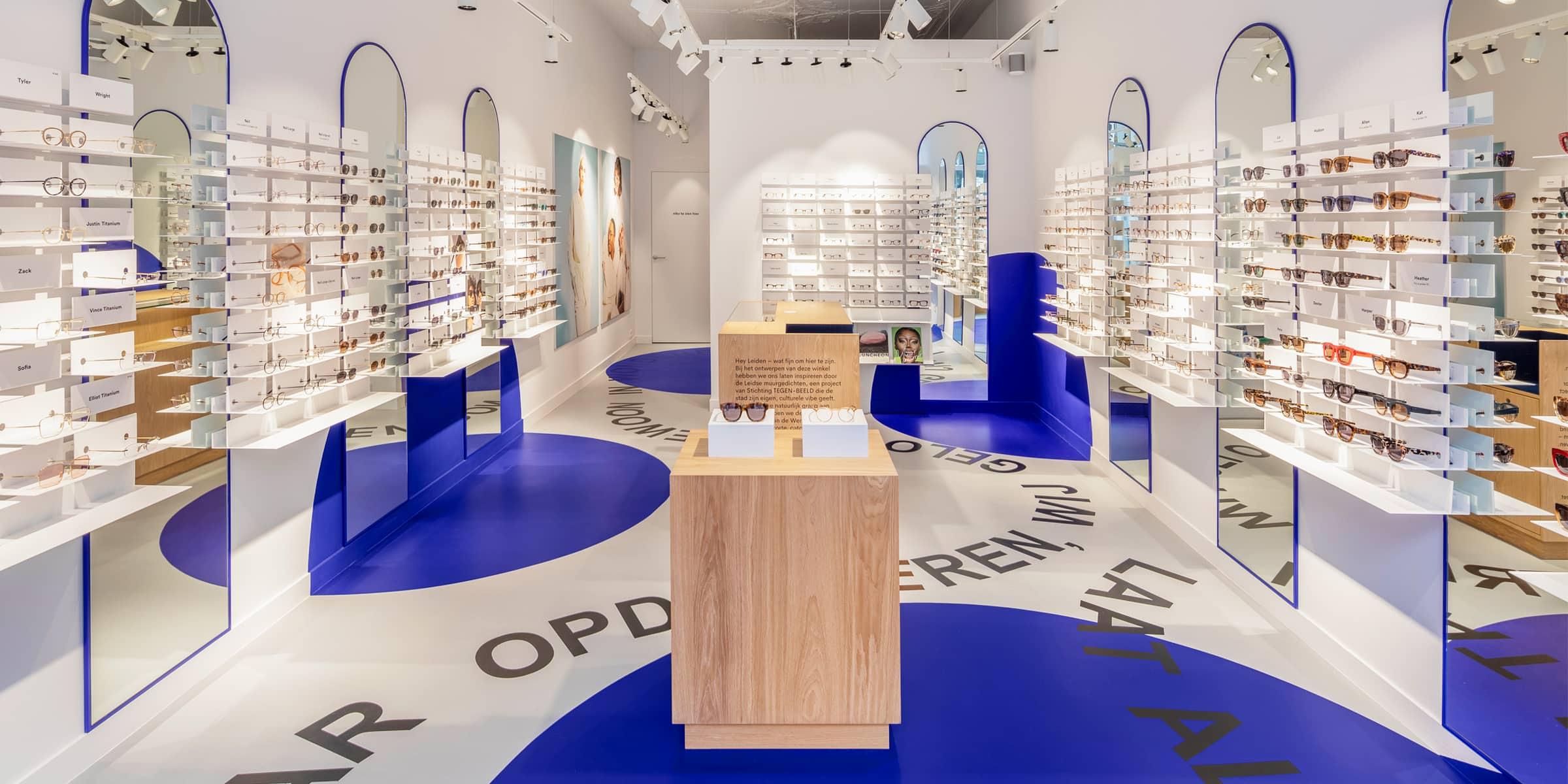 Modern eyewear store interior with white shelving units displaying various glasses