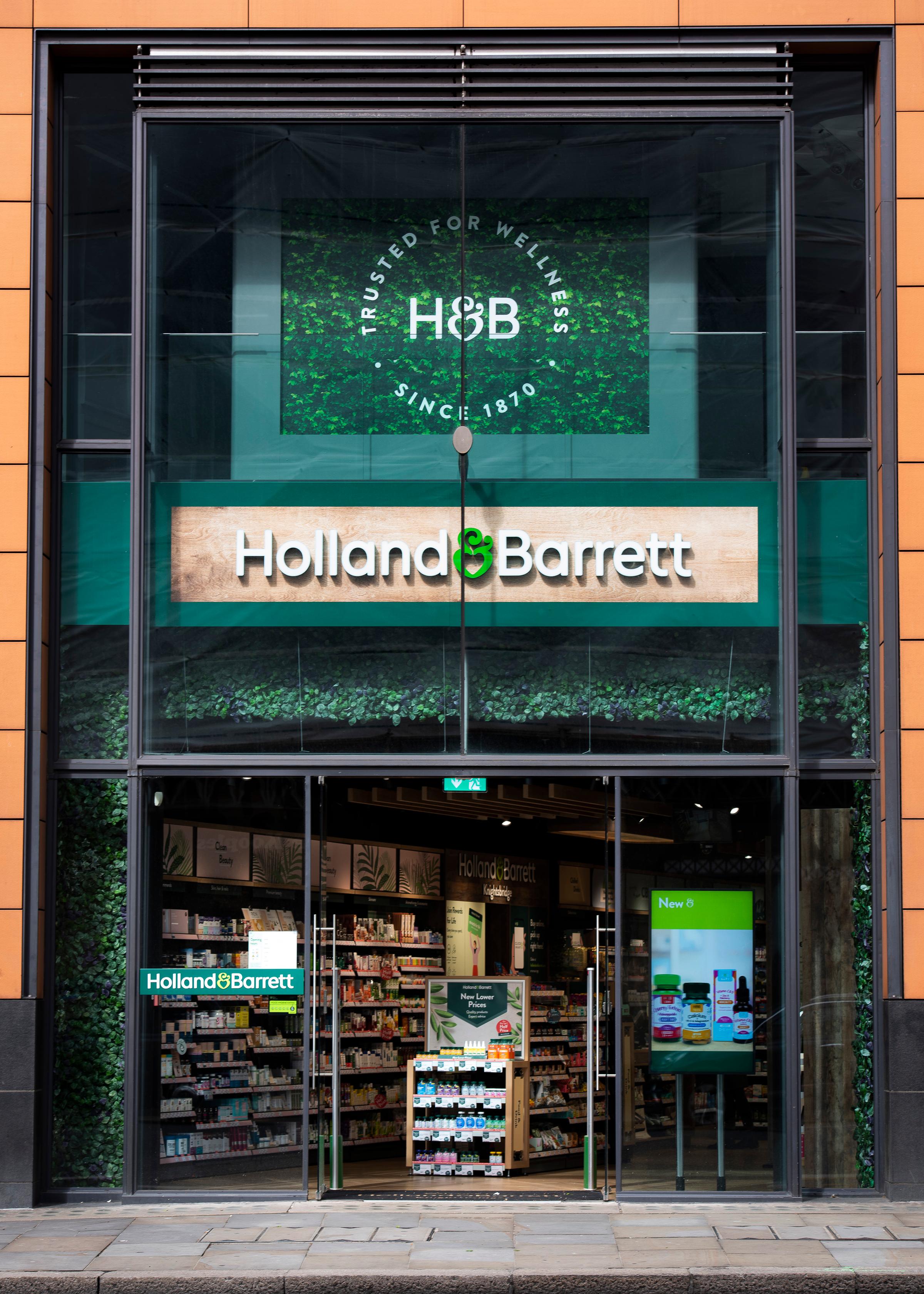 Exterior view of Holland & Barrett store with visible signage and product displays.