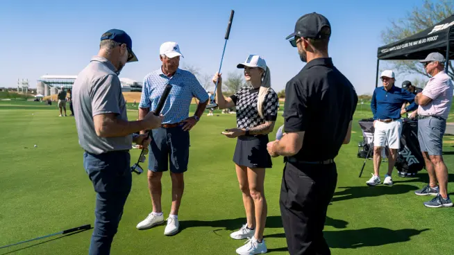 Golfers discussing payment options at a golf course with an Adyen terminal visible nearby.