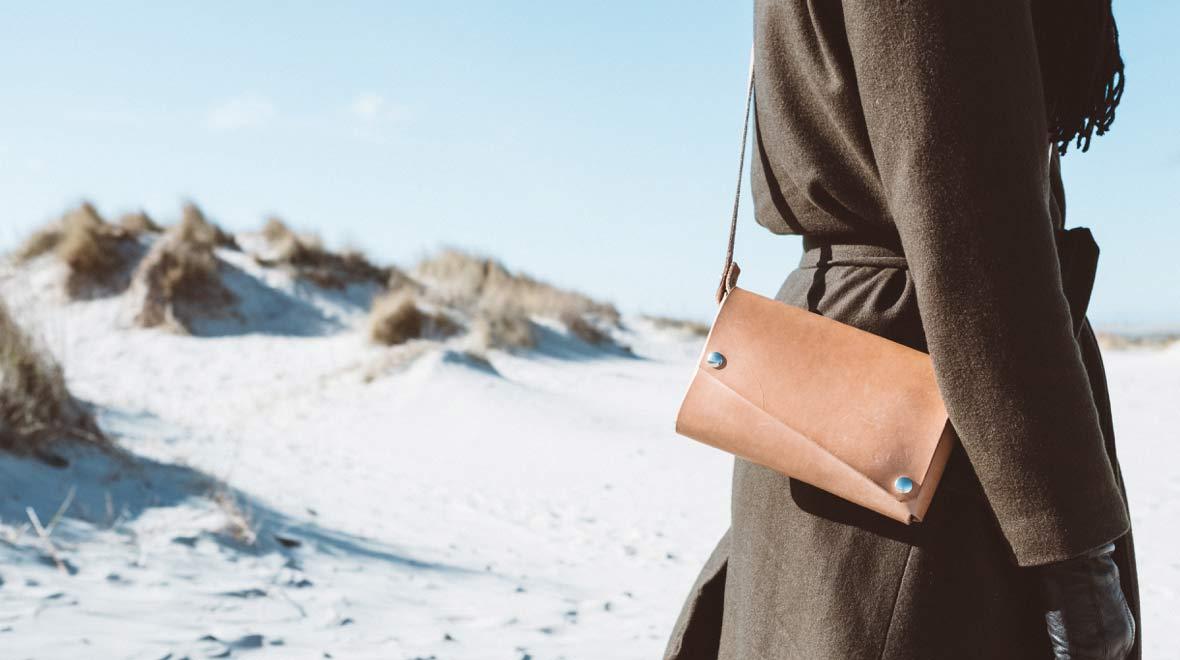 Person wearing brown handbag