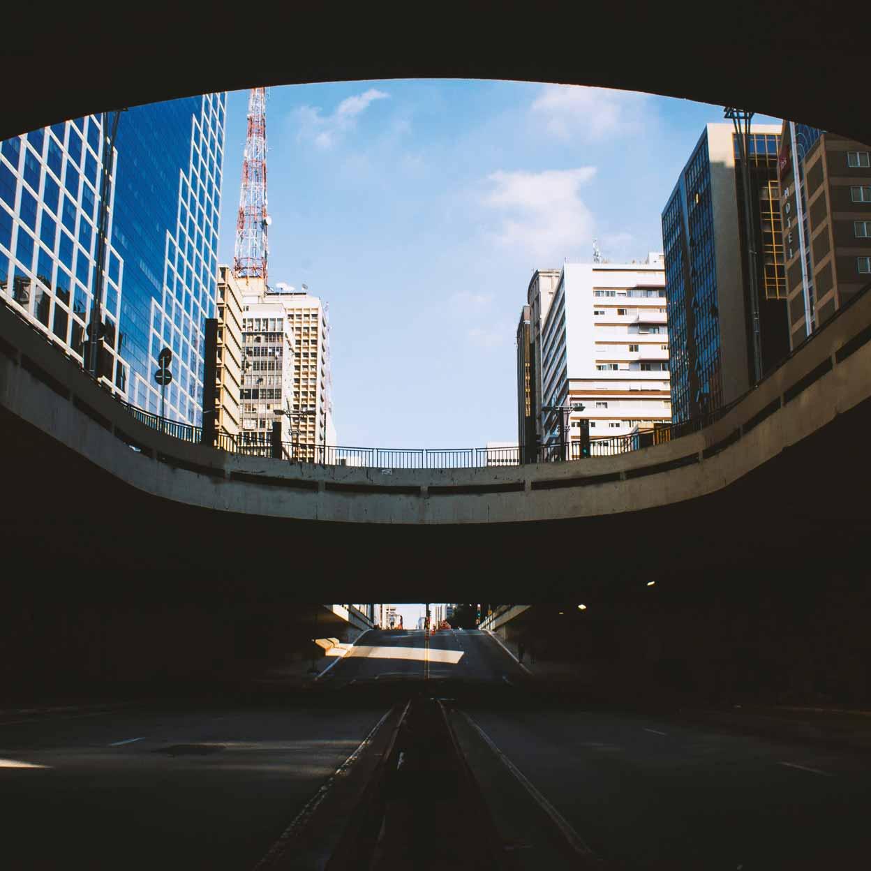 Urban overpass creating a frame for the skyline with buildings and a clear sky.