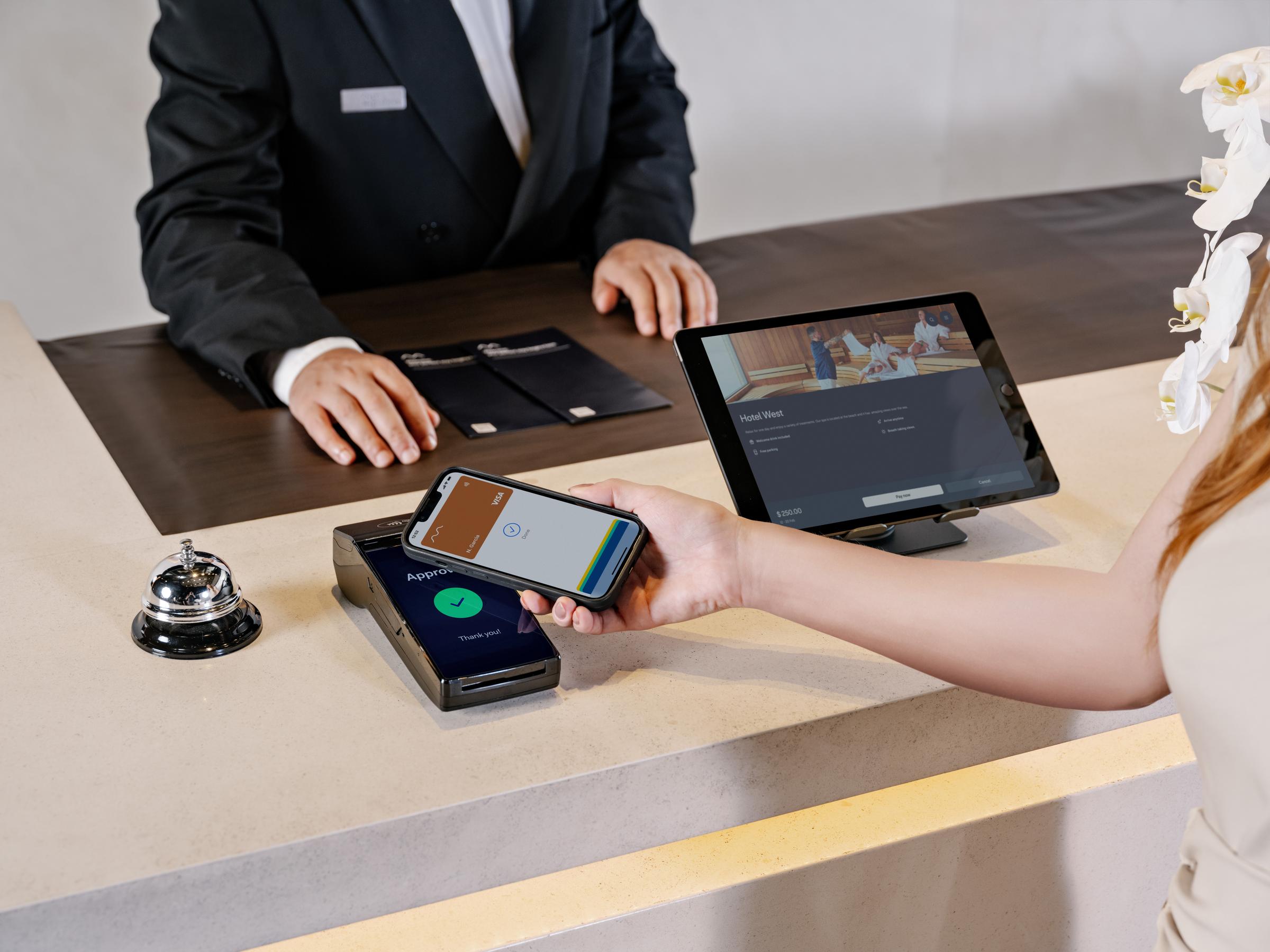 woman paying het stay at a hotel at s1f2 terminal