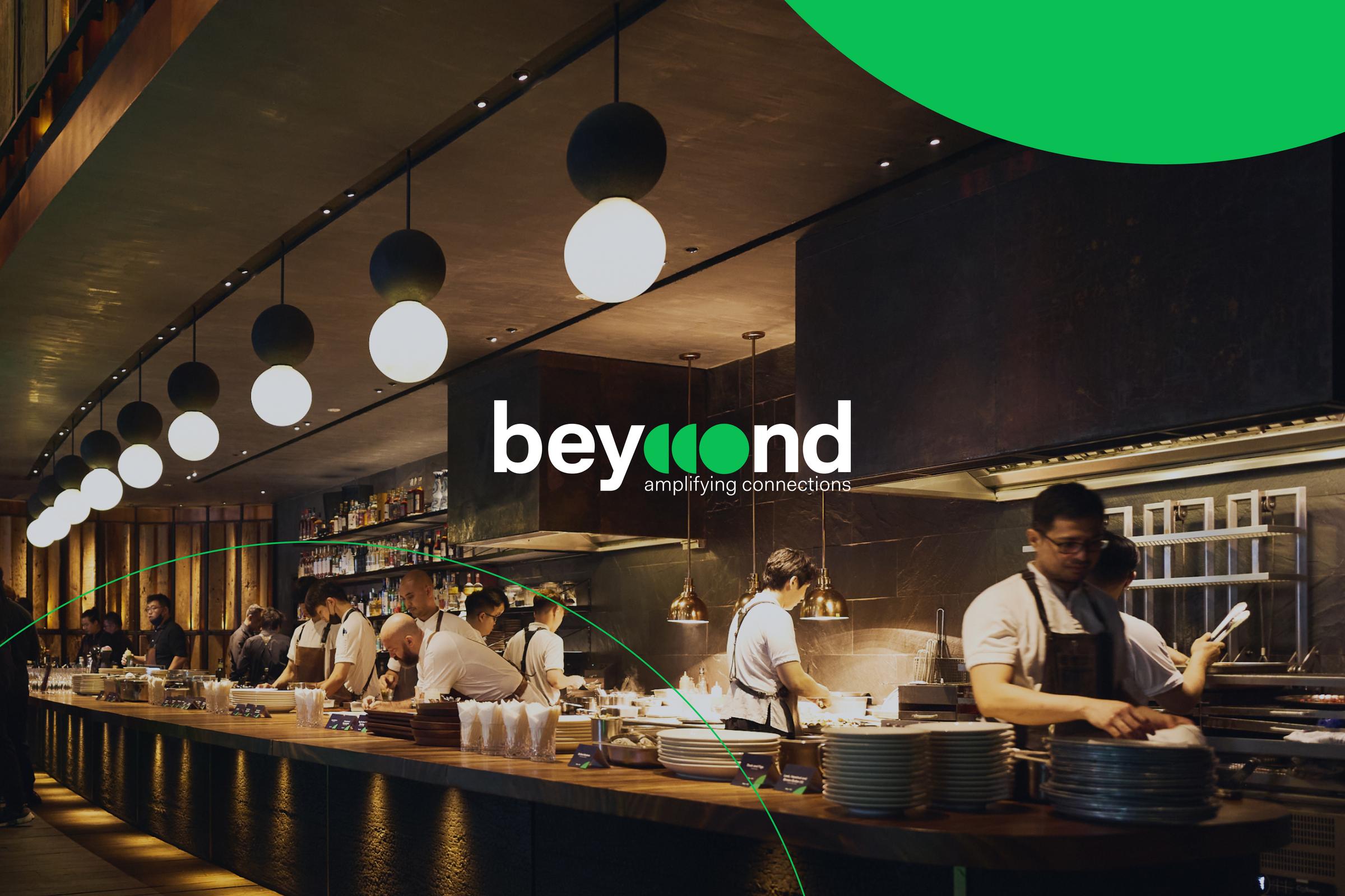 Restaurant with an open kitchen with Adyen's Beyond event logo.