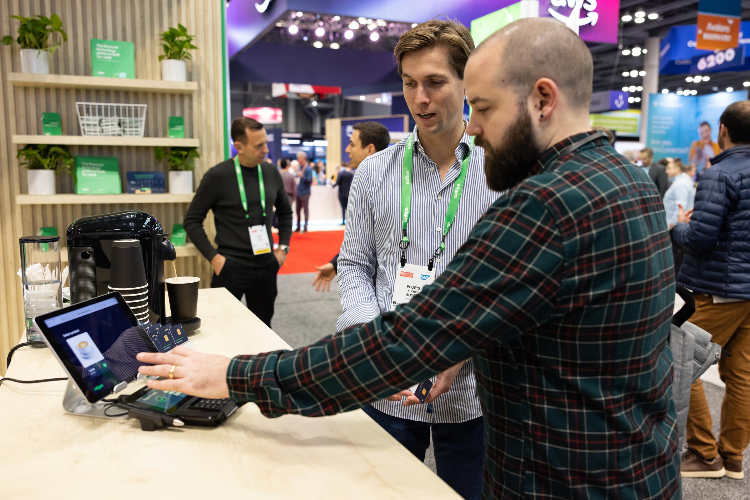 Photograph of merchant using our demo to buy coffee at our conference booth